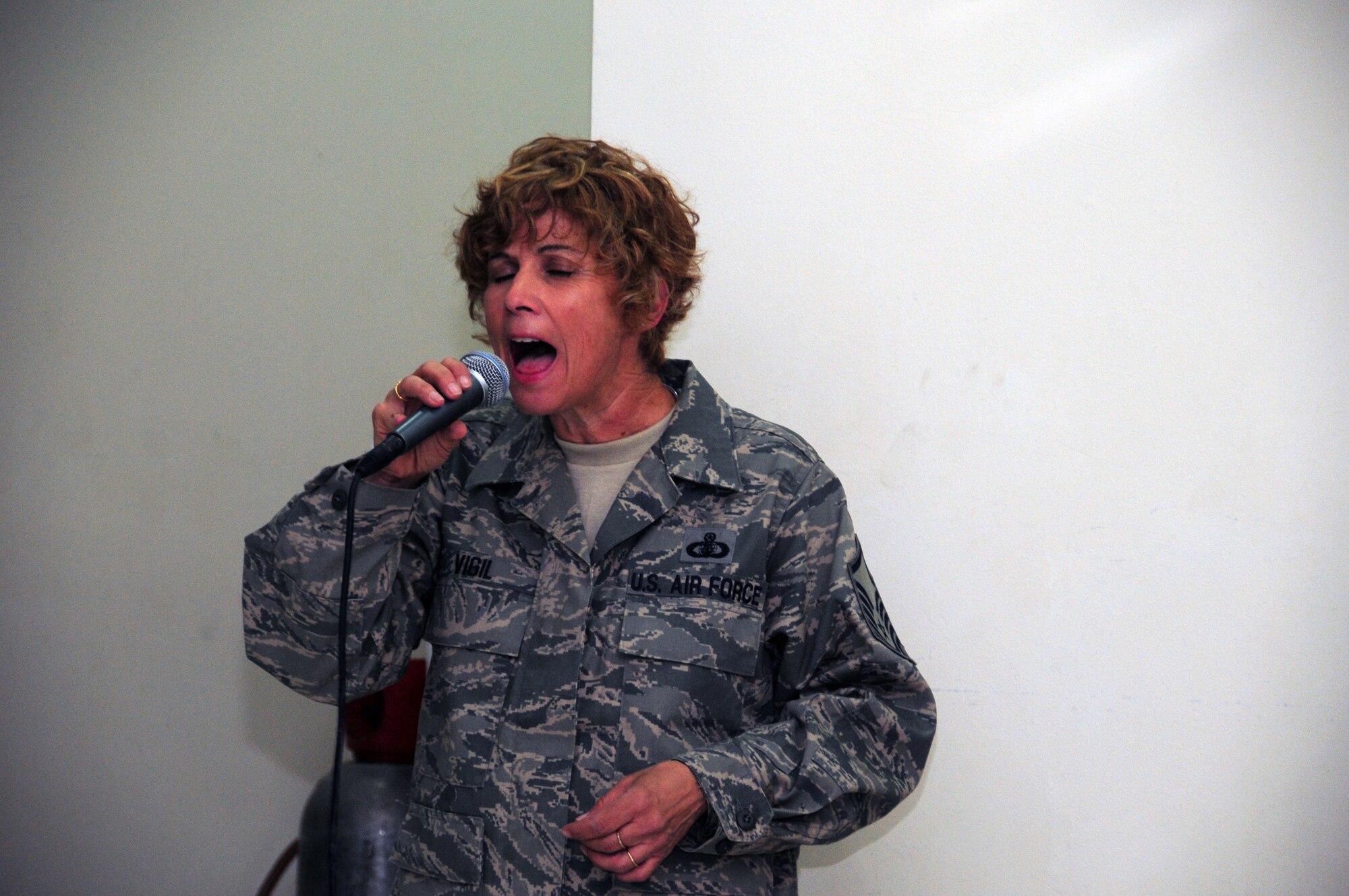 U.S. Air Force Master Sgt. Verlie Vigil, vocalist for the U.S. Air Forces Central Command band, "Vector" entertains the men and women of the 386th Expeditionary Security Forces Squadron here at an air base in Southwest Asia May 21, 2010. This eight person ensemble also performs as a trio or brass quintet if the function calls for a smaller act.  (U.S. Air Force photo by Staff Sgt. Lakisha A. Croley/Released)