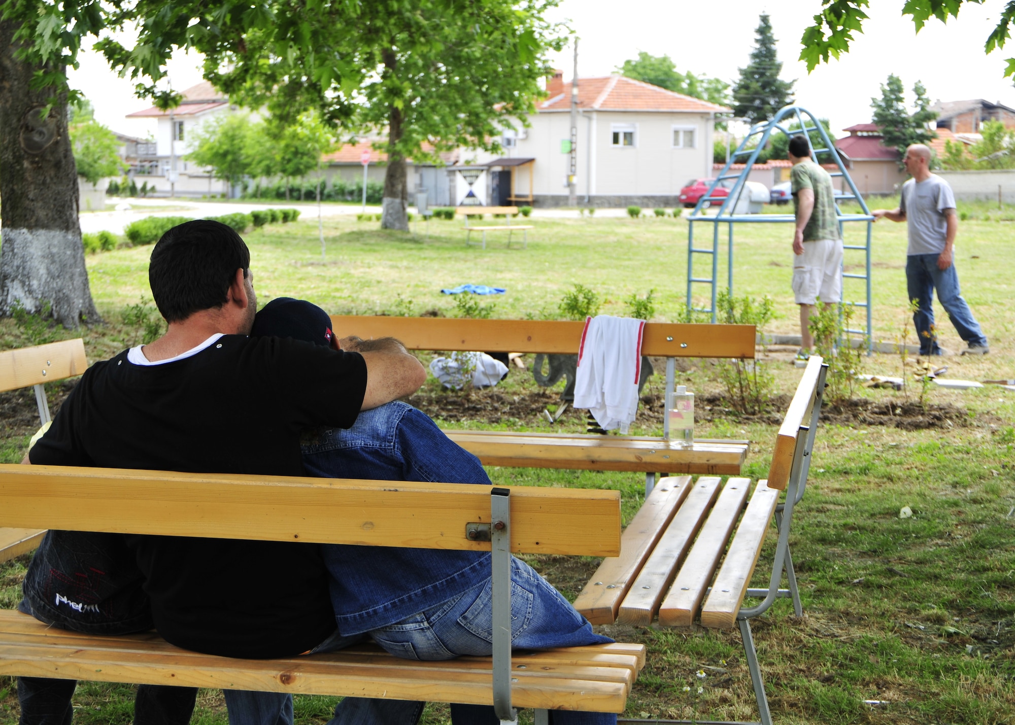 GRAF IGNATIEVO, Bulgaria - A Bulgarian family watches as Capt. Mark Perry (left), 493rd Fighter Squadron F-15 pilot, and Tech. Sgt. Phillip Ford (right), 48th Maintenance Group Quality Assurance inspector, paint playground equipment at the park in Graf Ignatievo, Bulgaria, May 22. (U.S. Air Force photo/Airman 1st Class Tiffany M. Deuel)