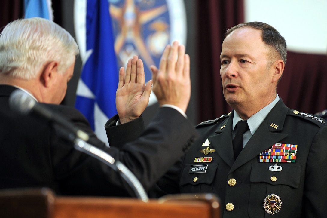 Defense Secretary Robert M. Gates delivers the oath of office to Army Gen. Keith Alexander as he is promoted to General during the activation ceremony of U.S. Cyber Command on Fort Meade, Md., May 21, 2010.