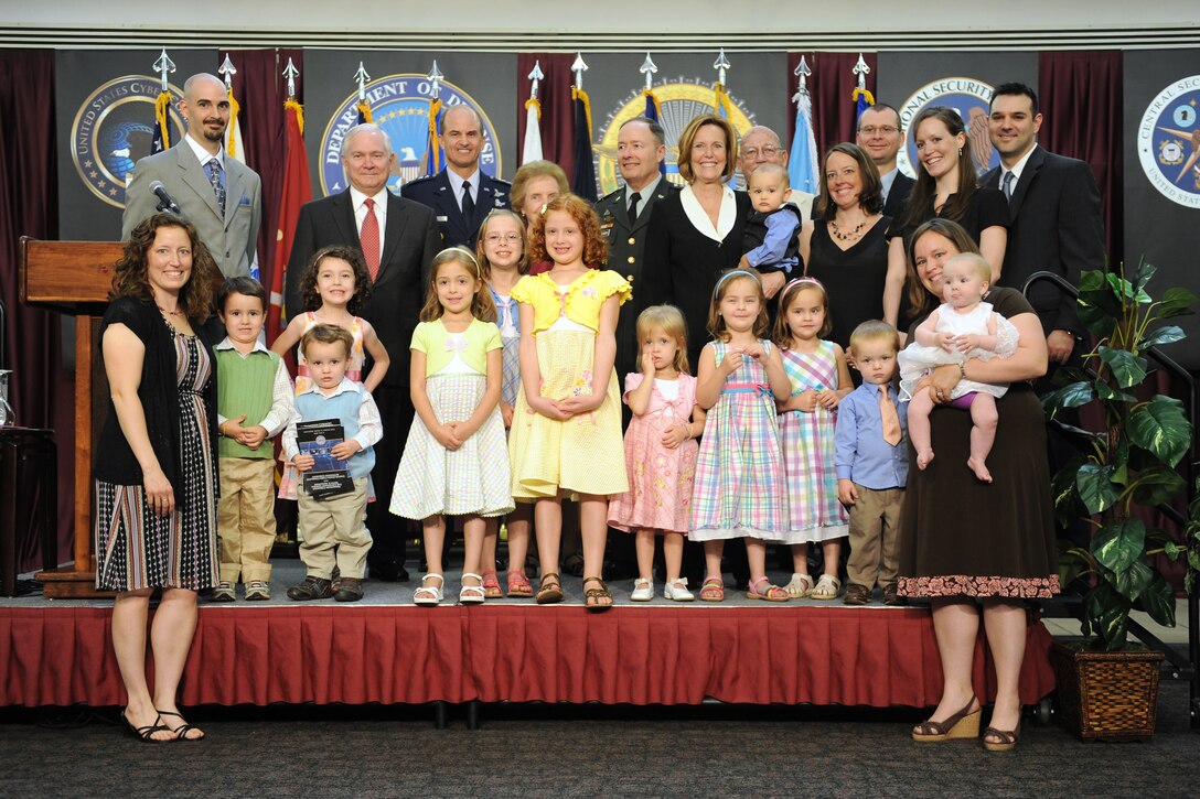 Defense Secretary Robert M. Gates, back second from left, Air Force Gen. Kevin P. Chilton, commander of U.S. Strategic Command, third from left, Army Gen. Keith Alexander, center, and his wife Deborah, take a group photo with Alexander's family during the activation ceremony of U.S. Cyber Command on Fort Meade, Md., May 21, 2010.
