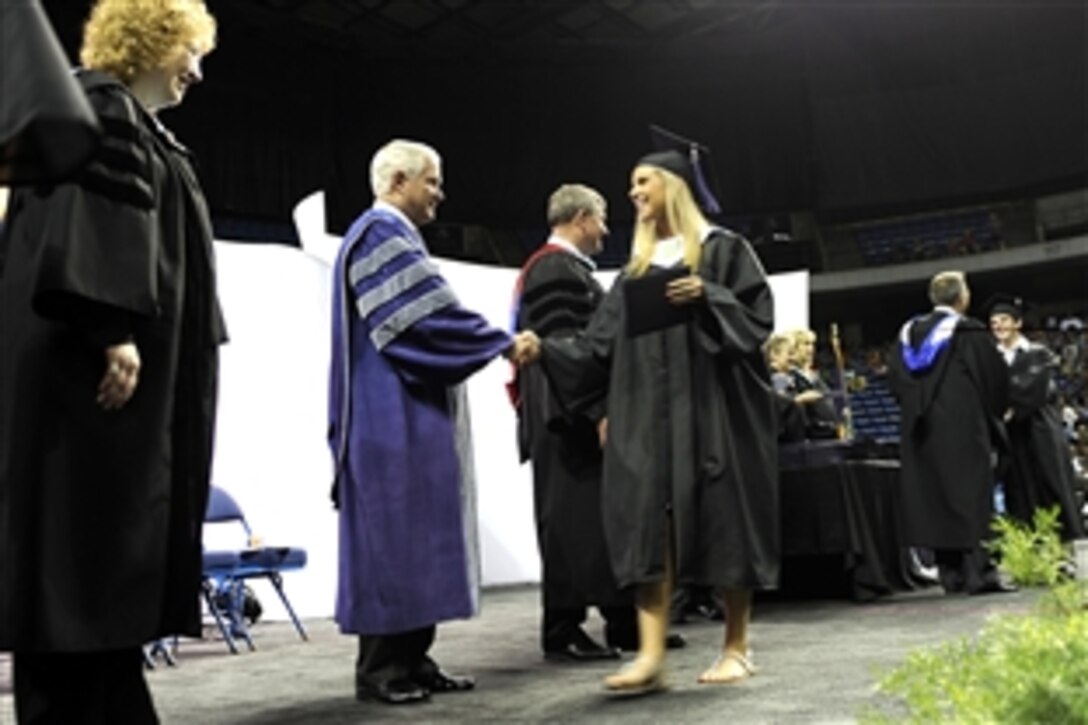 Defense Secretary Robert M. Gates congratulates a graduate of Blue Valley Northwest High School during the school's graduation ceremony at Kemper Arena in Kansas City, Mo., May 23, 2010. 
