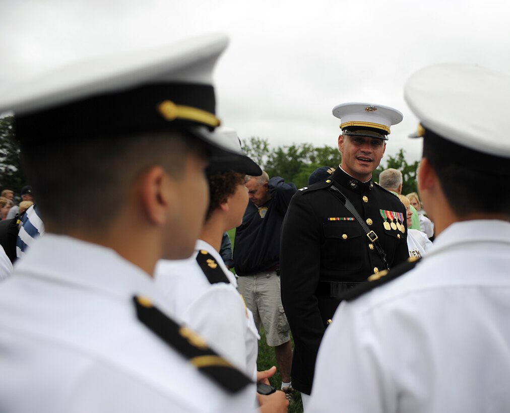 Capt. John McLaughlin, the platoon commander of the United States Marine Silent Drill Platoon, talks with midshipmen after a performance at the United States Naval Academy during Commsioning Week May 24. McLaughlin, a 2005 graduate of the United States Naval Academy, was a plebe at the academy when we saw the Silent Drill Platoon perform for the first time.