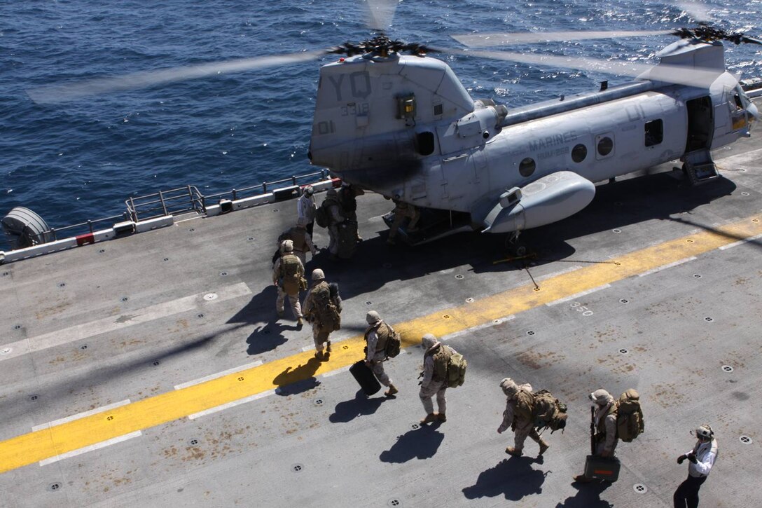 U.S. Marines from 2nd Battalion, 11th Marine Regiment, 1st Marine Division, board a CH-46E Sea Knight on the flight deck of the USS Bonhomme Richard during training exercise Dawn Blitz, May 24. The exercise is a joint forces maneuver that involves more than 4,000 Marines and sailors and nine Navy ships that began May 24, and is scheduled through June 4.