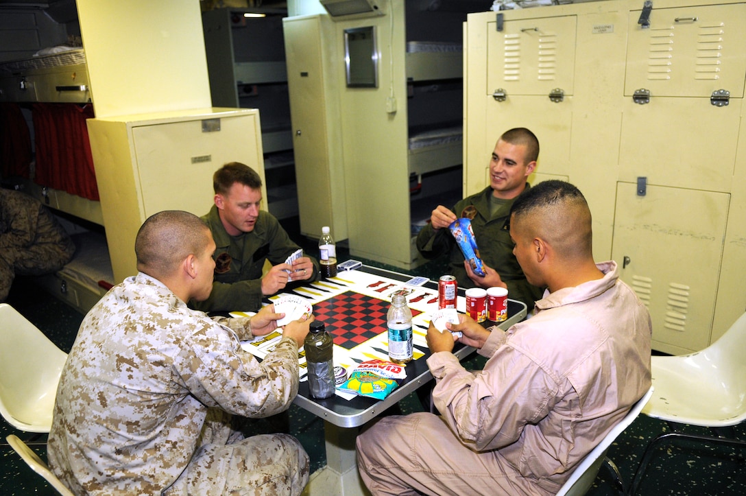 Marine Attack Squadron 513 Marines enjoy their off time playing spades in the crew quarters of the USS Bonhomme Richard, which is afloat near the coast of San Clemente Island, Calif., after a day of landing and refueling AV-8B Harriers May 25, 2010. The squadron supported the first Exercise Dawn Blitz, an exercise that affords Marines and sailors an opportunity to practice large-scale amphibious assault operations that combine long-range support and close-air support over a two-week period. The Corps intends to hold the exercise annually.