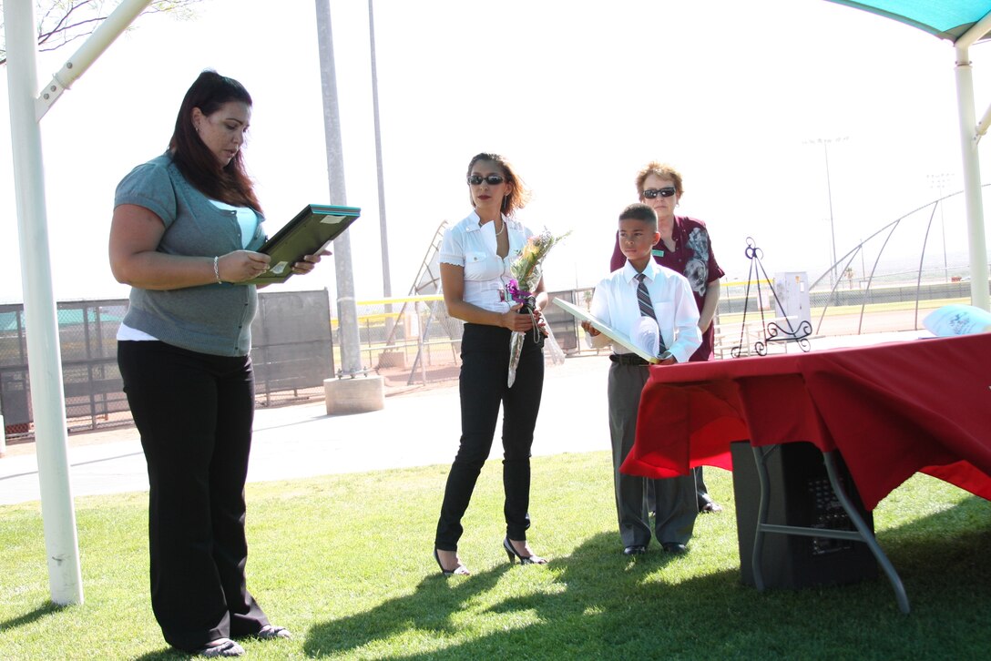 Isaiah Garcia [right] looks at his mom, Crystal Castaneda, with pride at Felix Field May 25 as he received his award for winning second place in the Armed Services YMCA art contest. Isaiah is the first child from the Twentynine Palms area to ever receive this award.