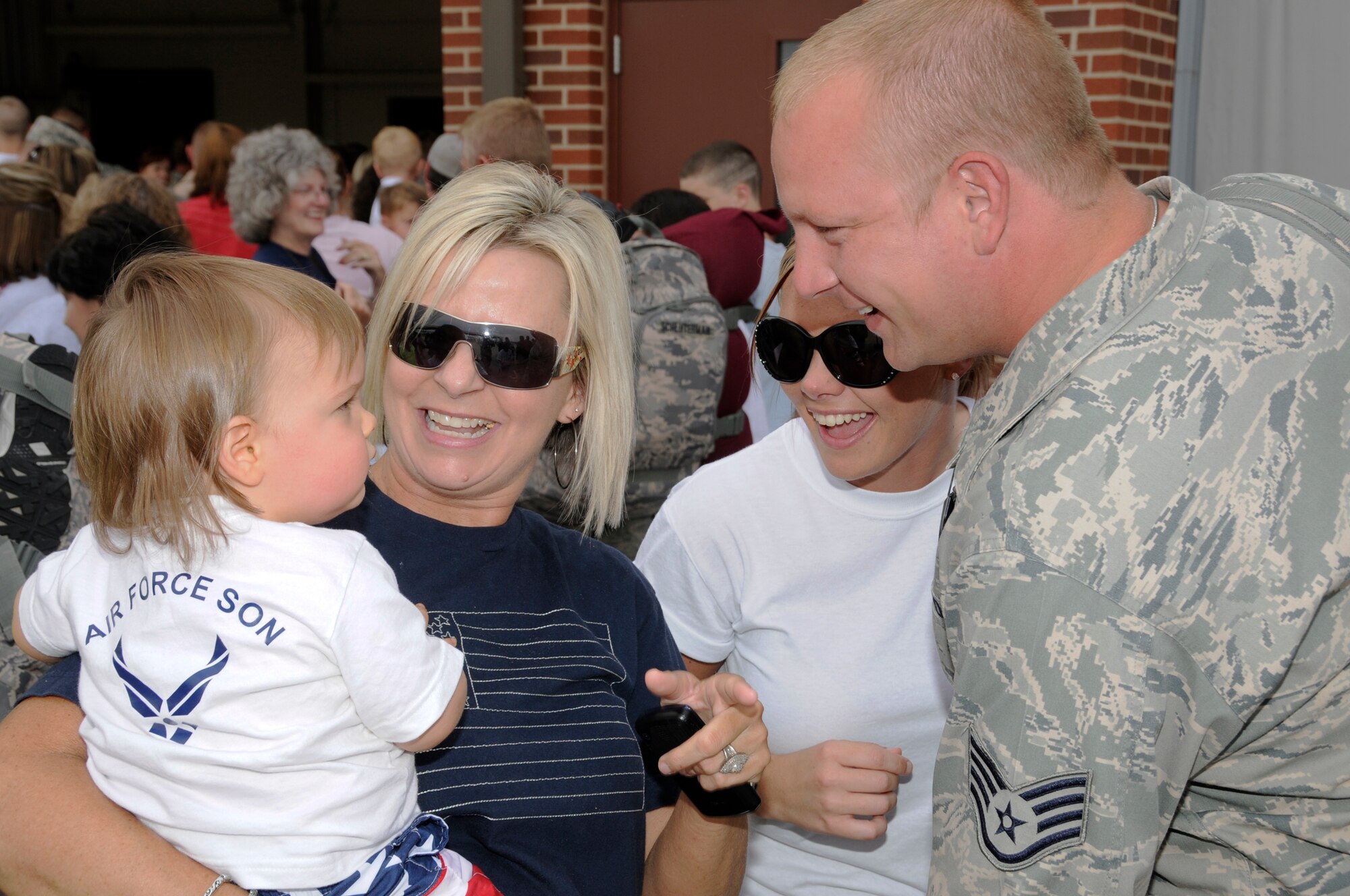 An Airman with the Arkansas Air National Guard's 188th Fighter Wing reunites with his family Tuesday, May 25. The Airmen returned from an Aerospace Expeditionary Force (AEF) deployment to Kandahar Airfield in Afghanistan. Approximately 50 Guardsmen from the 188th returned from Kandahar Tuesday. (U.S. Air Force photo by Senior Master Sgt. Dennis Brambl/188th Fighter Wing Public Affairs)