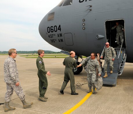 Master Sgt. Danny Staggs, right, shakes hands with Col. Tom Anderson, 188th Fighter Wing commander, May 25, at the 188th. Staggs was the first Airmen to depart a Boeing C-17 Globemaster III based out of Charleston Air Force Base, S.C. Approximately 50 Airmen from the Arkansas Air National Guard's 188th Fighter Wing returned Tuesday, May 25, from an Aerospace Expeditionary Force (AEF) deployment to Kandahar Airfield in Afghanistan.  (U.S. Air Force photo by Senior Master Sgt. Dennis Brambl/188th Fighter Wing Public Affairs)