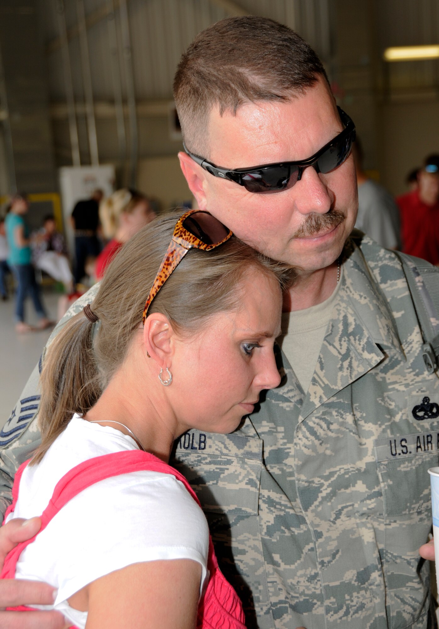 Master Sgt. Michael Kolb hugs his wife, Tina, May 25 at the 188th Fighter Wing's Consolidated Maintenance Facility. Kolb was one of 50 Airmen that returned Tuesday from an Aerospace Expeditionary Force (AEF) deployment to Kandahar Airfield in Afghanistan.  (U.S. Air Force photo by Senior Master Sgt. Dennis Brambl/188th Fighter Wing Public Affairs)