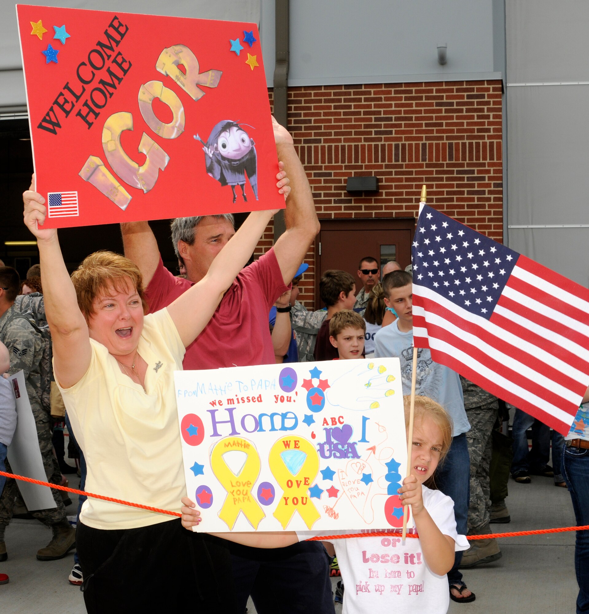 Family members of 188th Fighter Wing Airmen display signs to welcome back deployed Guardsmen, who returned from an Aerospace Expeditionary Force (AEF) deployment to Kandahar Airfield in Afghanistan May 25.  (U.S. Air Force photo by Capt. Heath Allen/Arkansas National Guard Public Affairs)