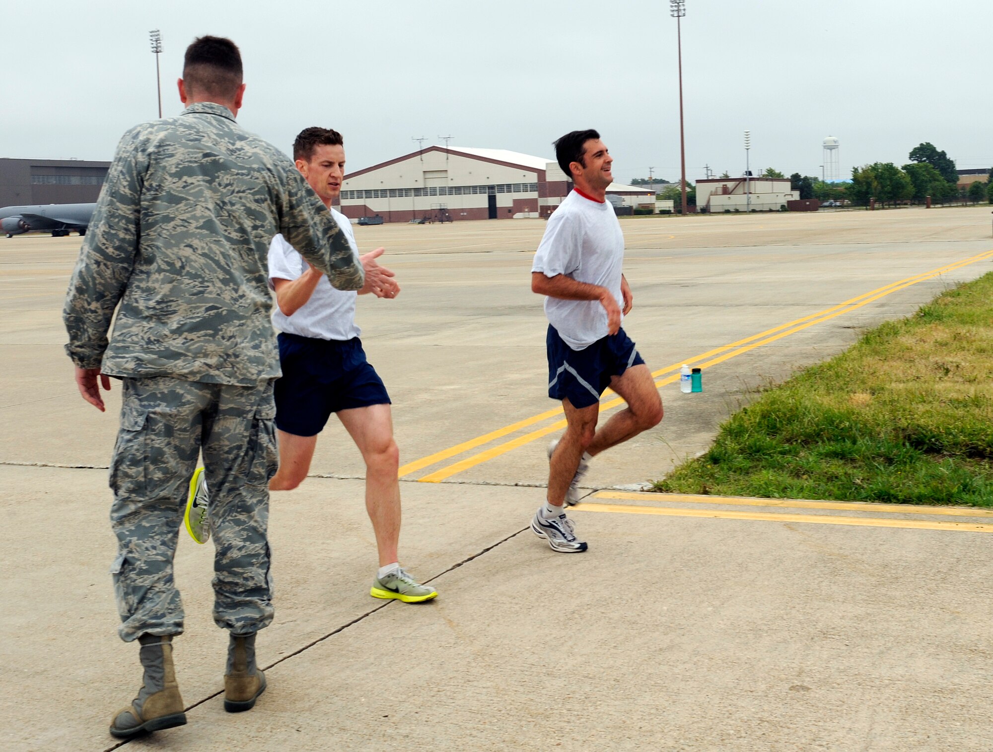 LANGLEY AIR FORCE BASE, Va. -- Capt. Keagan McLeese, 27th Fighter Squadron flight commander, and Maj. Greg Voelkel, 71 FS assistant director of operations, cross the finish line tied for first place during the Wingman Day fun run May 14. The 1.5-mile run on the flightline kicked off the day of events, filled with a variety of activities focusing on safety, alcohol and suicide awareness. (U.S. Air Force photo/Airman 1st Class Gul Crockett)