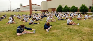 LANGLEY AIR FORCE BASE, Va. -- Airmen from the 1st Equipment Maintenance Squadron stretch before the Wingman Day fun run May 14. The 1.5-mile run on the flightline kicked off the day of events, filled with a variety of activities focusing on safety, alcohol and suicide awareness. (U.S. Air Force photo/Airman 1st Class Gul Crockett)
