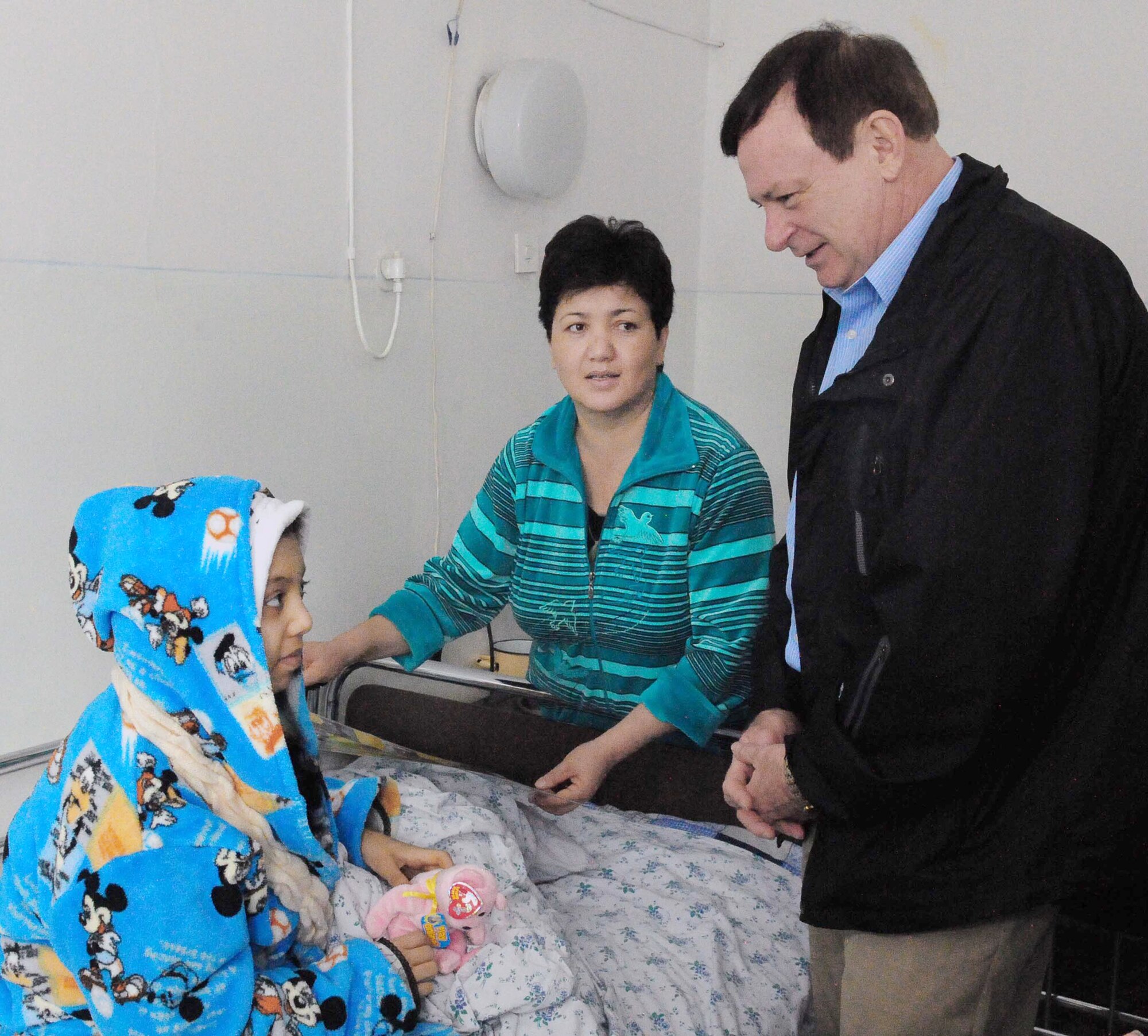 Chaplain (Lt. Col.) James Kinsey speaks to Firuza Nurahunova, a 13-year-old Kyrgyz girl, and her mother, Shakura, March 21, 2010, at the Transit Center at Manas, Kyrgyzstan. Ms. Nurahunova was the 150th child to receive life-saving surgery funded by Airmen at the Transit Center. Chaplain Kinsey is the 376th Air Expeditionary Wing head chaplain. (U.S. Air Force photo/Staff Sgt. Carolyn Viss)