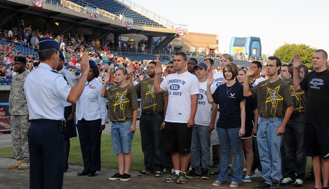 LANGLEY AIR FORCE BASE, Va. -- Maj. Gen. David Edgington, U.S. Joint Forces Command chief of staff, administers the Oath of Enlistment to military Delayed Entry Program participants during the opening ceremony of the Norfolk Tides baseball club’s 15th annual Military Appreciation Night May 22. The Tides hosts the event each year to honor service members from all branches of the military. (U.S. Air Force photo/Airman 1st Class Gul Crockett)