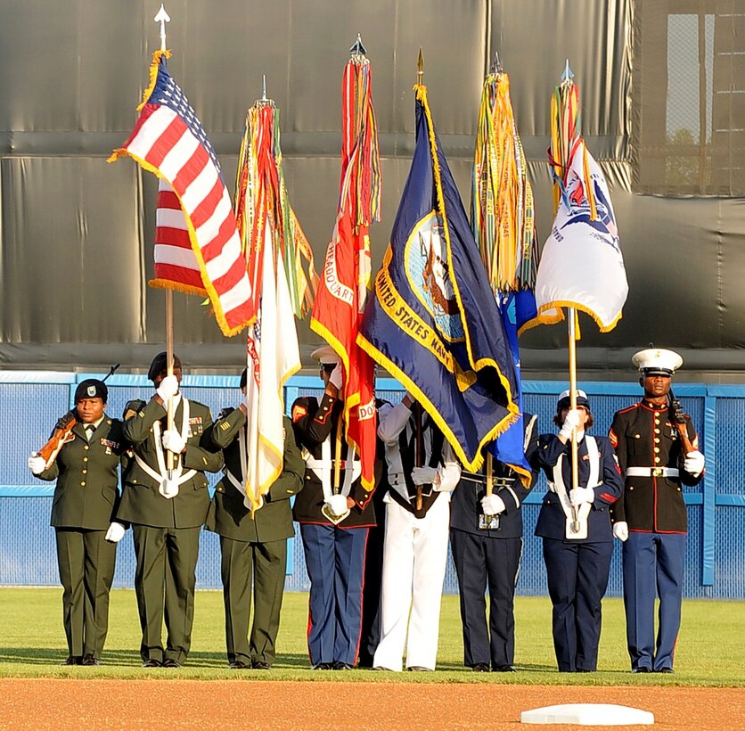 LANGLEY AIR FORCE BASE, Va. -- A joint service color guard presents the colors during the opening ceremony of the Norfolk Tides baseball club’s 15th annual Military Appreciation Night. The Tides hosts the event each year to honor service members from all branches of the military. (U.S. Air Force photo/Airman 1st Class Gul Crockett)
