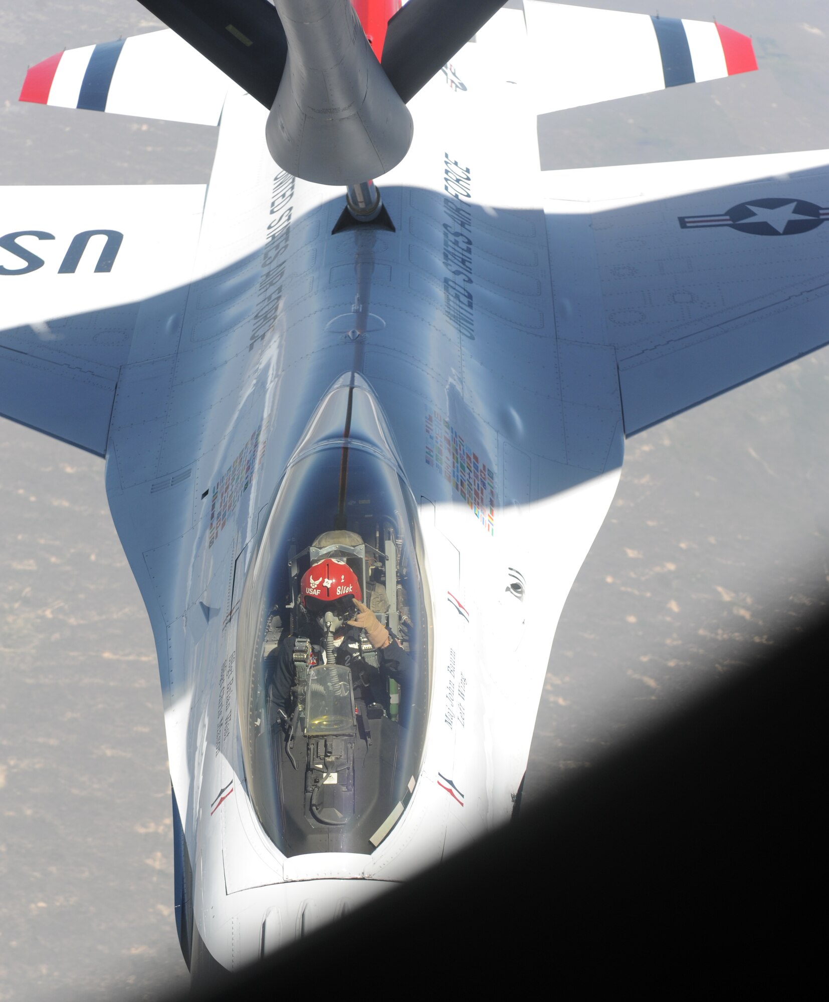 Maj. John Baum, U.S. Air Force Thunderbirds number two, gives a “rock- on” signal after his refueling with the 905th Air Refueling Squadron spouses incentive flight May 23. The Thunderbirds were on their way to Colorado Springs, Colo. after participating in an air show at Grand Forks Air Force Base, N.D. (U.S. Air Force photo by Staff Sgt. Suellyn F. Nuckolls)