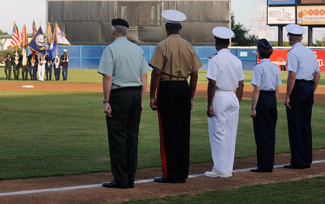 LANGLEY AIR FORCE BASE, Va. -- Senior military representatives look on as a joint service color guard presents the colors during the opening ceremony of the Norfolk Tides baseball club’s 15th annual Military Appreciation Night May 22. The Tides hosts the event each year to honor service members from all branches of the military. (U.S. Air Force photo/Airman 1st Class Gul Crockett)