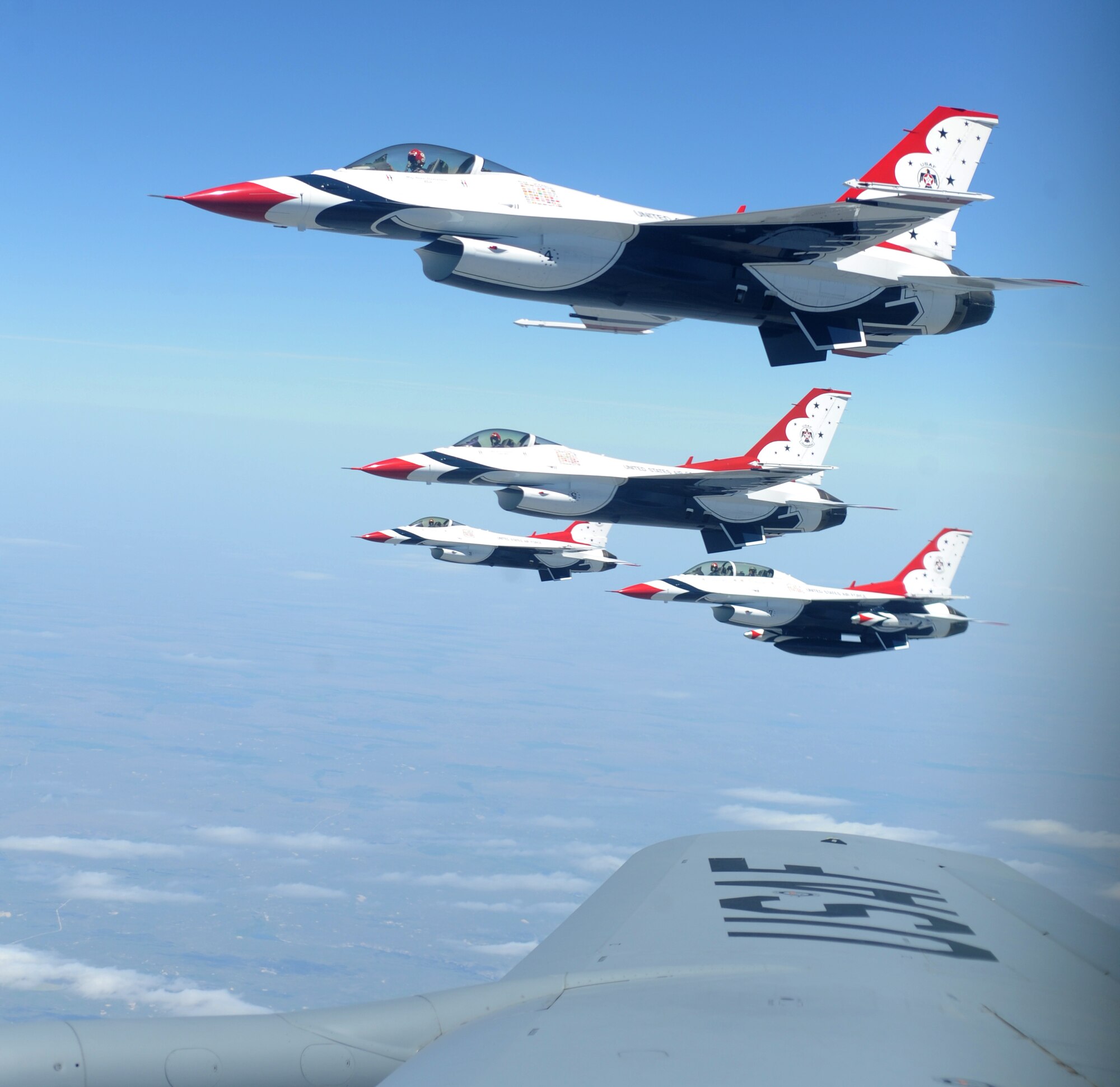 U.S. Air Force Thunderbirds fly along the wing of a KC-135 Stratotanker during an air refueling incentive flight for the spouses of the 905th Air Refueling Squadron May 23. The KC-135 refueled the Thunderbirds after they performed in an air show at Grand Forks Air Force Base, N.D. while on their way to Colorado Springs, Colo.  (U.S. Air Force photo by Staff Sgt. Suellyn F. Nuckolls)