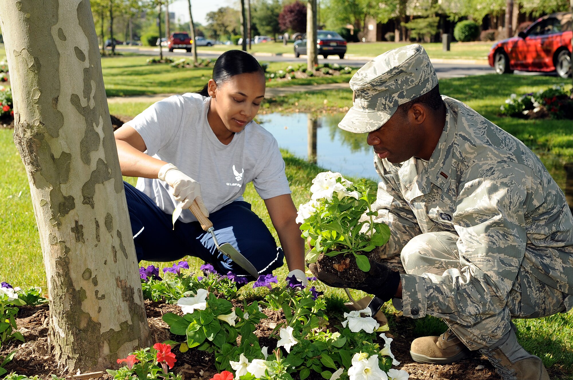 Staff Sgt. Lakeisha McKinstry and 2nd Lt. Duaita Roseboro,contracting specialists of the 87th Contracting Squadron, work together to plant flowers here May 20 in honor of Base Pride Day. (U.S. Air Force photo/Wayne Russell)
