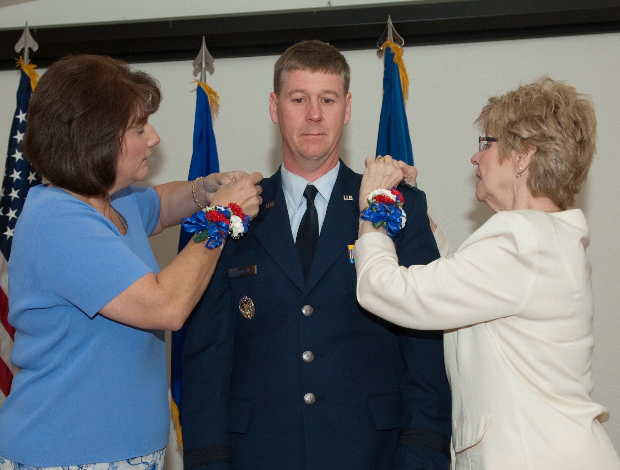 Brig. Gen. William J. Thornton, 412th Test Wing commander, has his star ceremoniously pinned on by his wife, Lisa, and his mother, Kay Page, in a promotion ceremony at Club Muroc, May 21. General Thornton was officially promoted May 7. Club Muroc's Alliance ballroom was filled with friends, family, base leadership and workers.  (Air Force photo by Mike Yncera)  