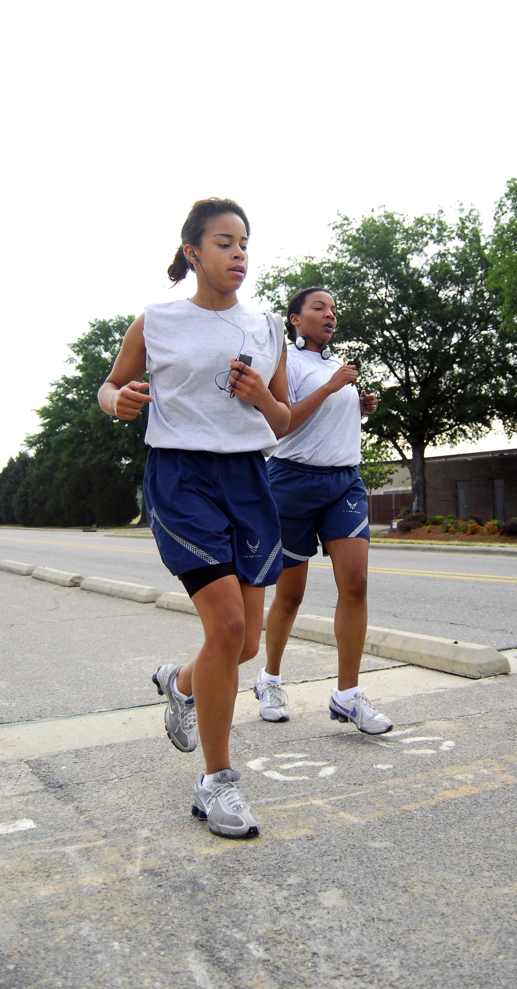 Senior Airman Sabrina Blayde and Tech Sgt. Nakesha Nipes both from 43rd FSS, cross the finish line during the 1.5-mile run on the perimeter of the Pope flightline during their annual PT test, May 20. PT tests are administered to Airmen to assess, maintain and regulate fitness. (U.S. Air Force Photo/2nd Lt. Cammie Quinn)