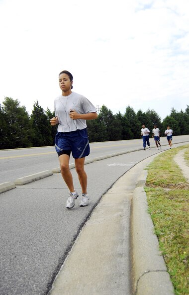 Senior Airman Sabrina Blayde, 43rd Force Support Squadron, runs along the perimeter of the Pope flightline for the 1.5-mile run during her annual PT test May 20. New PT test standards include revised age groups and minimum requirements to pass the push up, sit up and run portions of the test. (U.S. Air Force Photo/2nd Lt. Cammie Quinn)