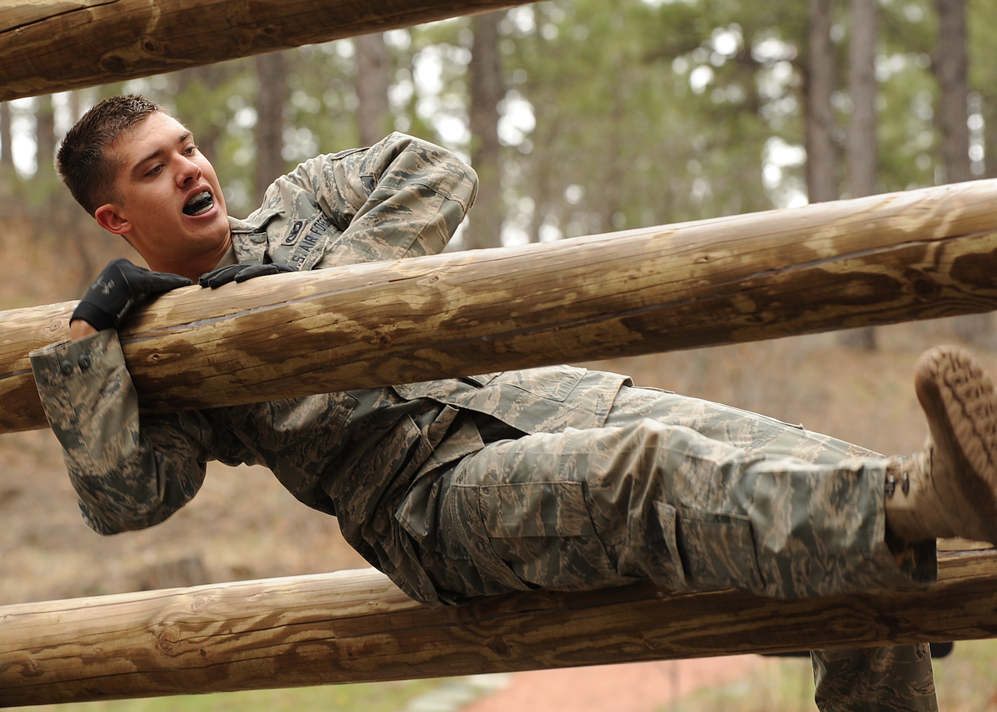 Airman 1st Class Christopher Uremovich, 460th Security Forces Squadron, pulls himself over an obstacle during Guardian Challenge May 19. (U.S. Air Force photo by Tech. Sgt. Matt Lohr)