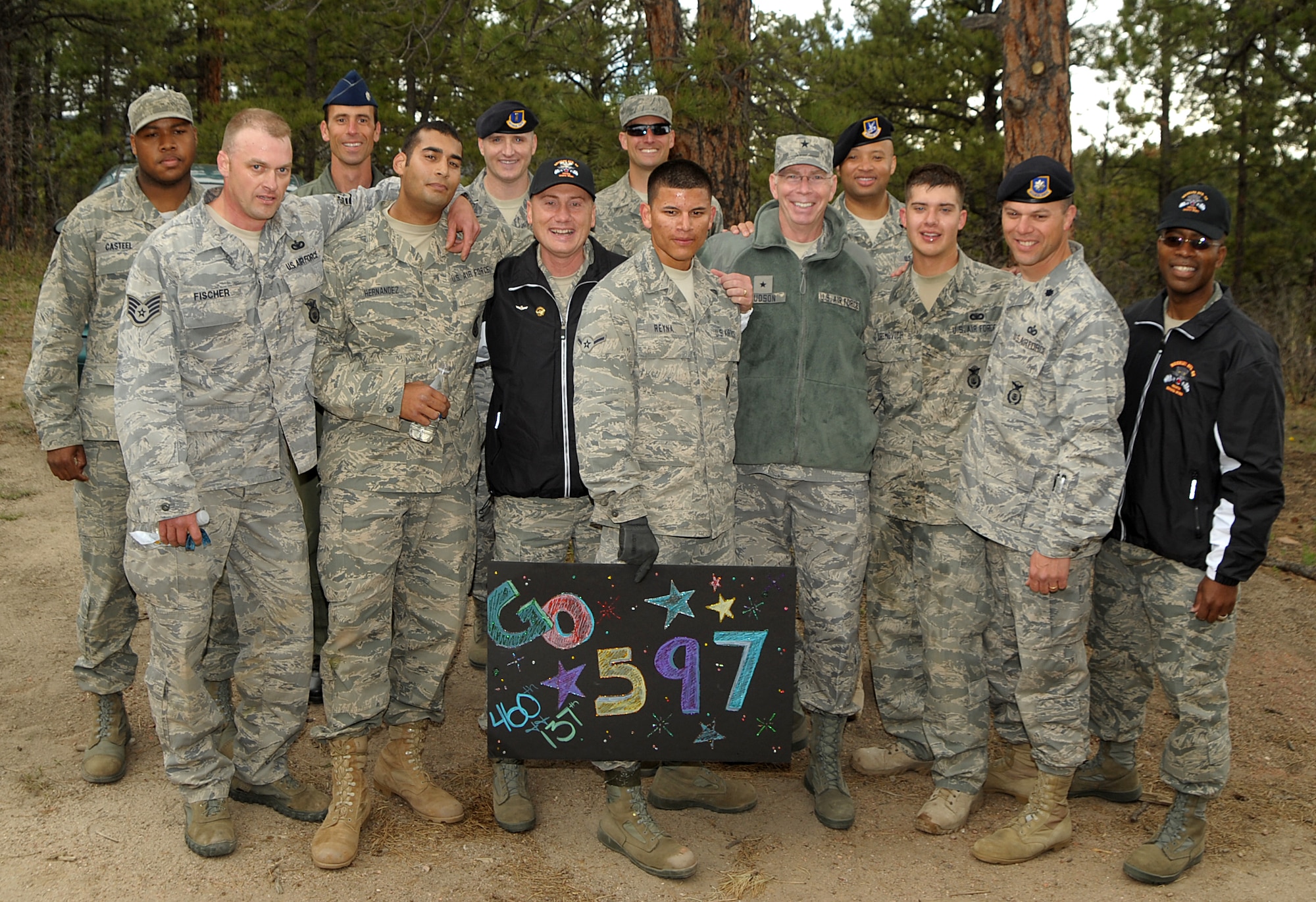 Members of the combined 460th Space Wing and 137th Space Warning Squadron Guardian Challenge team pose with their supporters after the competition May 19. The "Go 597" sign refers to the combined 460th SW and 137th team. (U.S. Air Force photo by Duncan Wood)