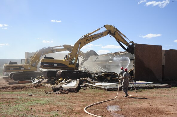 Members of the 203rd Red Horse Squadron, Virginia Beach Va., demolish the condemned dining hall at St. Michael’s Association for Special Education school in Window Rock, Ariz., on May 19, 2010. The Red Horse team, along with the 240th Civil Engineering Flight, 140th Wing, Colorado Air National Guard, are at St. Michael’s breaking ground on new facilities across campus. The effort to upgrade the complex for physically and mentally handicapped children and adults is part of the National Guard’s Innovative Readiness Training program, a civil-military affairs program that links military units with civilian communities for humanitarian projects. Throughout the next five years several Civil Engineering teams across the Air National Guard will rotate every two weeks to help this under privileged school.
 
(U.S. Air Force photo by Staff Sgt. Nicole Manzanares /RELEASED)
