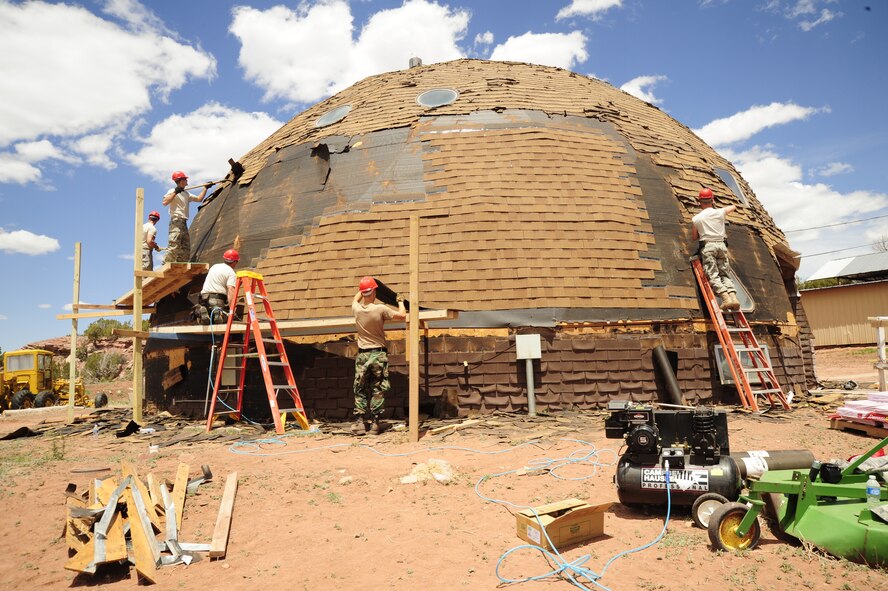 Members of the 203rd Red Horse Squadron, Virginia Beach Va., re-shingle a maintenance building at St. Michael’s Association for Special Education school in Window Rock, Ariz., on May 15, 2010. The Red Horse team, along with the 240th Civil Engineering Flight, 140th Wing, Colorado Air National Guard, are out at St. Michael’s preparing to break ground on new facilities across campus. The effort to upgrade the complex for physically and mentally handicapped children and adults is part of the National Guard’s Innovative Readiness Training program, a civil-military affairs program that links military units with civilian communities for humanitarian projects. Throughout the next five years, several Civil Engineering teams across the Air National Guard will rotate every two weeks to help renovate this underprivileged school. 

(U.S. Air Force photo by Staff Sgt. Nicole Manzanares /RELEASED)
