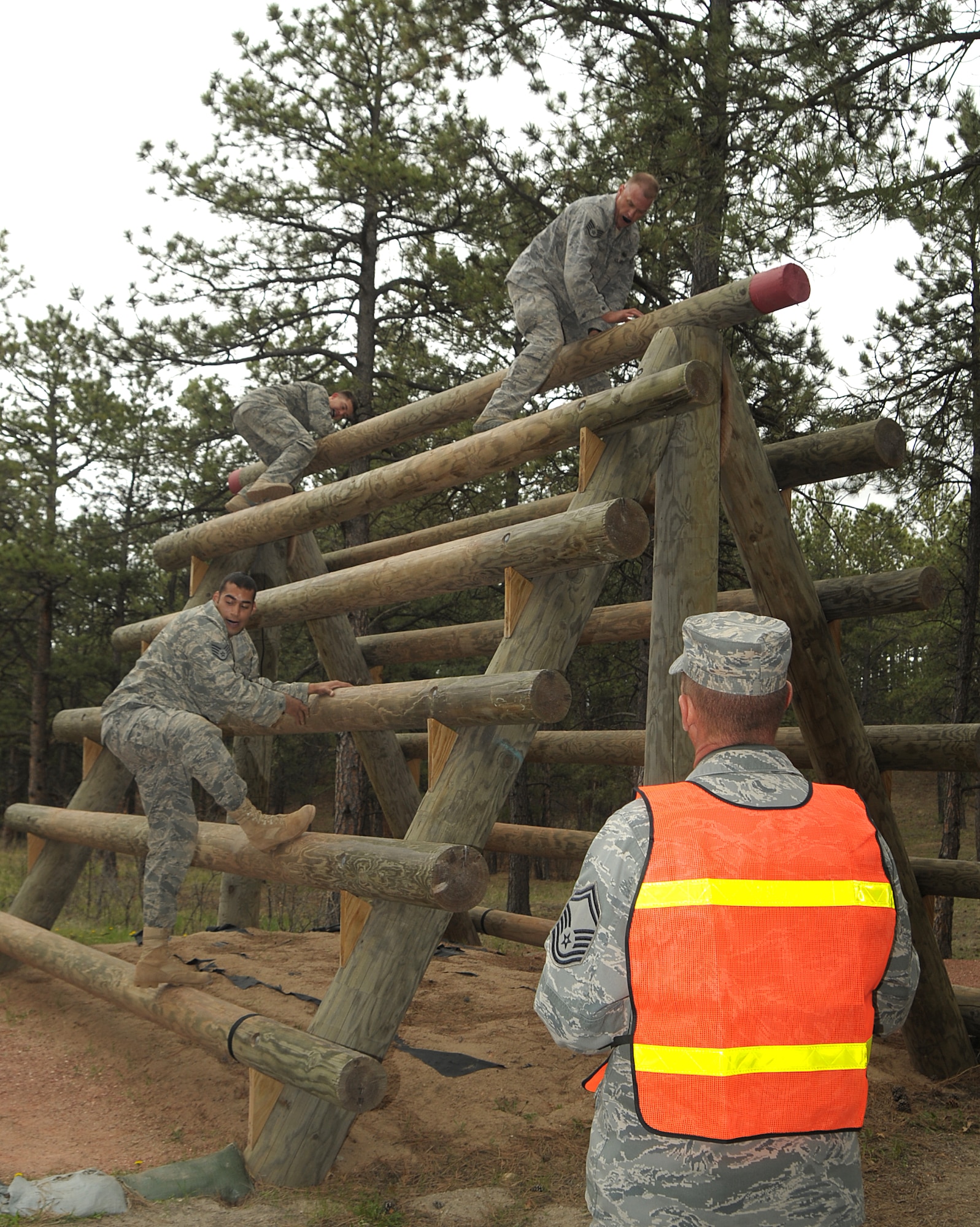 Members of the combined 460th Space Wing and 137th Space Warning Squadron team climb an obstacle during Guardian Challenge May 19. (U.S. Air Force photo by Duncan Wood)