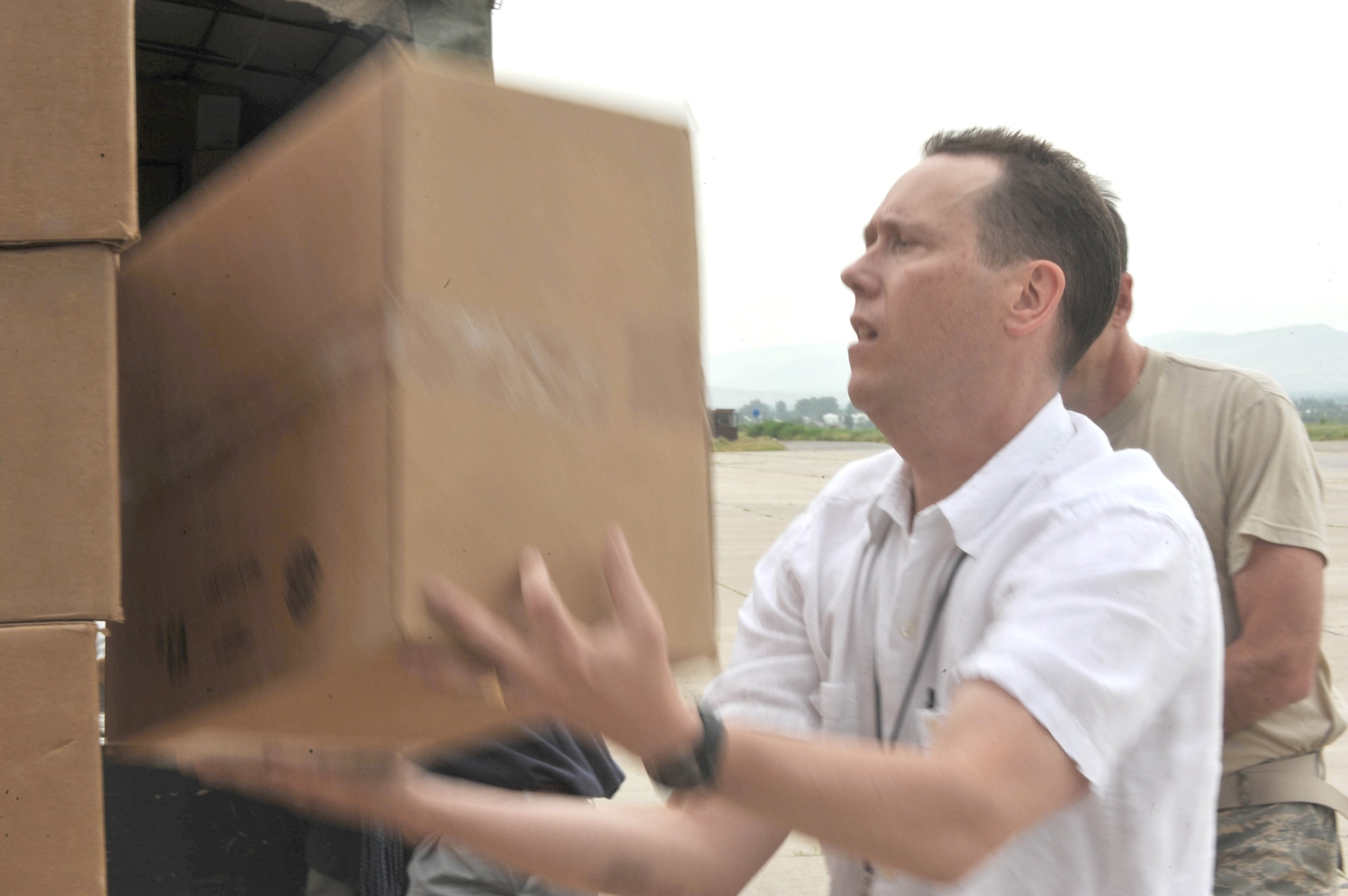 Kevin Allen helps load boxes of water, hygiene kits and medical supplies May 21, 2010, at Dushanbe International Airport, Tajikistan. The humanitarian cargo is for displaced Tajiks after floods and mudslides ravaged the Kulyab District earlier this month. Mr. Allen is the general services officer for the U.S. Embassy in Dushanbe. (U.S. Air Force photo/Staff Sgt. Quinton Russ)