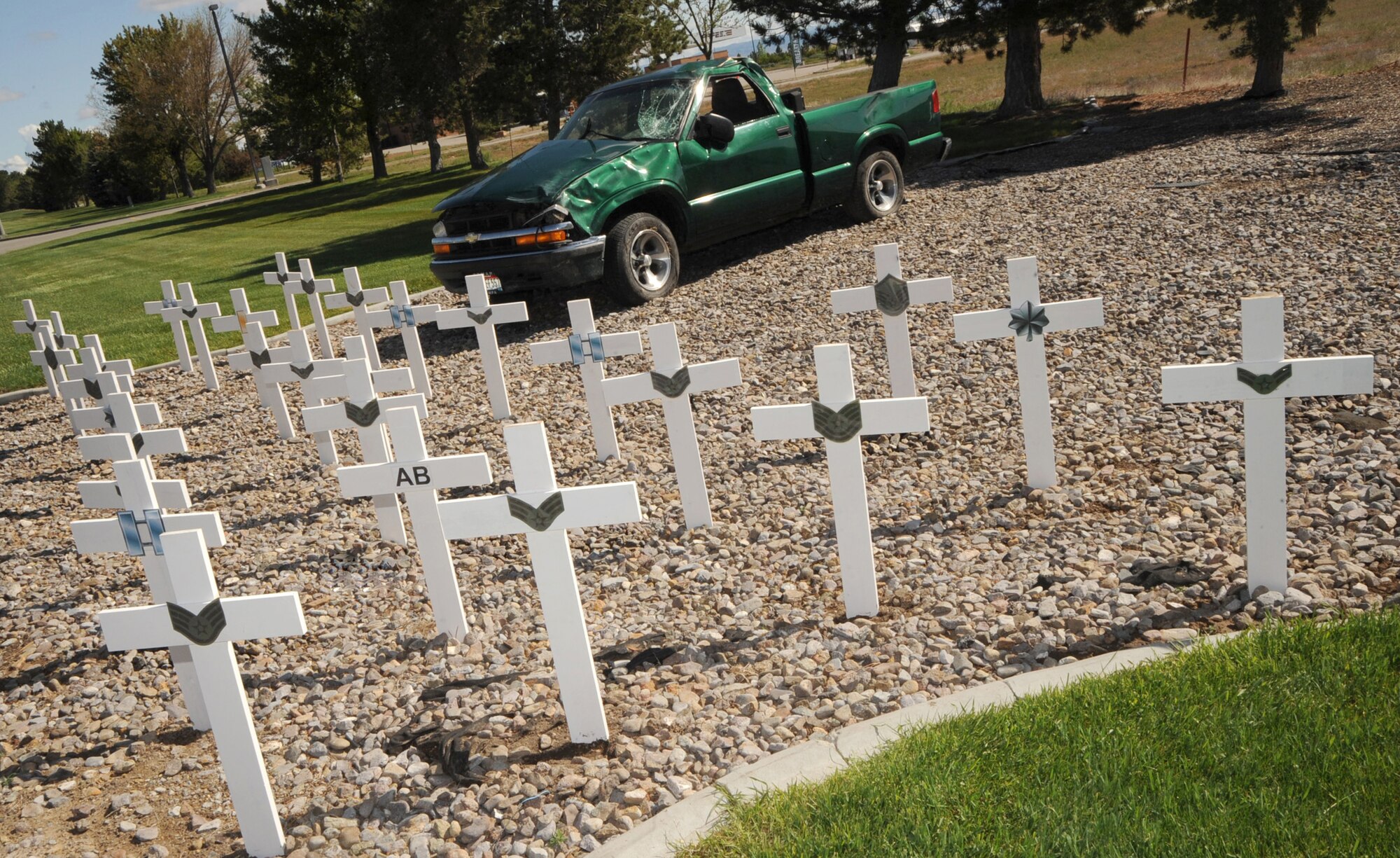 MOUNTAIN HOME AIR FORCE BASE, Idaho -- 30 crosses and a wrecked vehicle currently on display on Gunfighter Avenue leading out the main gate in memory of Airmen, across the , Air Force-who have been involved in mishaps this fiscal year.  Ranks are also placed on each cross representing the individual involved. The display is intended to remind everyone to be safe throughout the critical days of summer to prevent mishaps. (U.S. Air Force photo by Airman 1st Class Renishia Richardson)