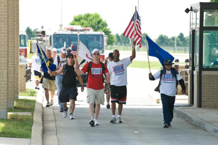 Participants in the 2010 USO Base 2 Base march enter the main gate at Dover Air Force Base, Del., May 21, 2010. The March is a 47-mile journey that starts at Delaware Air National Guard Headquarters and ends at Dover AFB. (U.S. Air Force photo/Roland Balik)