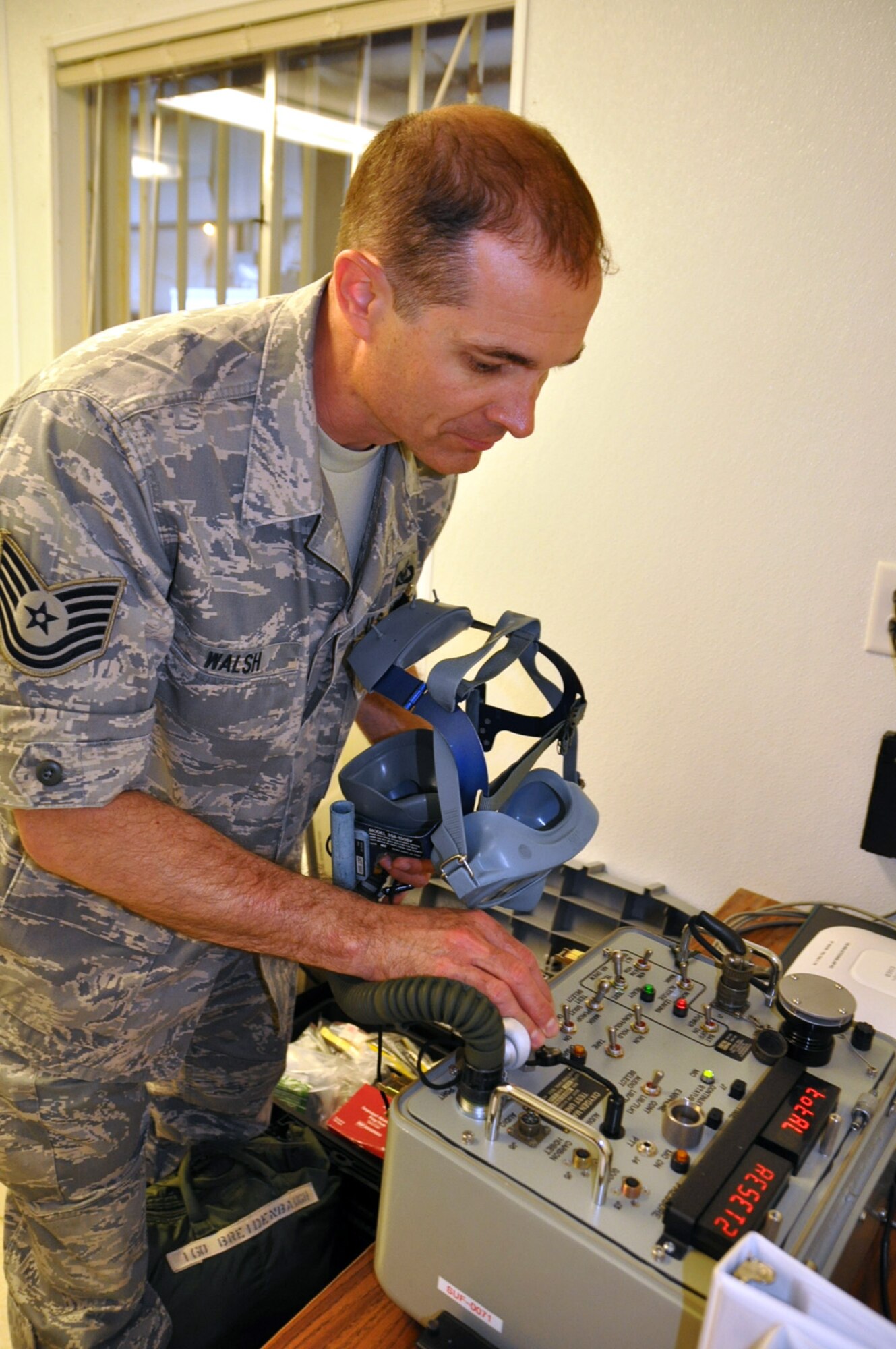 KILN, Miss. — U.S. Air Force Reserve Tech Sgt. Philip Walsh, an Aircrew Flight Equipment (AFE) specialist and Air Reserve Technician with the 910th Operation Support Squadron based at the Youngstown Air Reserve Station, Ohio, conducts an operational check of a quick-don mask using an oxygen mask test set at Stennis International Airport here, May 19, 2010. As an AFE technician, he maintains all of the emergency breathing equipment utilized by the aircrew on board a C-130. Other life saving equipment is positioned onboard in case of smoke or fume conditions. AFEs maintain the floatation gear the air crew will use in case of  an over water emergency. Sgt. Walsh and more than 50 YARS Reservists have been deployed to the Gulf of Mexico in support of the Deepwater Horizon oil spill mitigation since May 1. U.S. Air Force photo/Maj. Brent Davis
