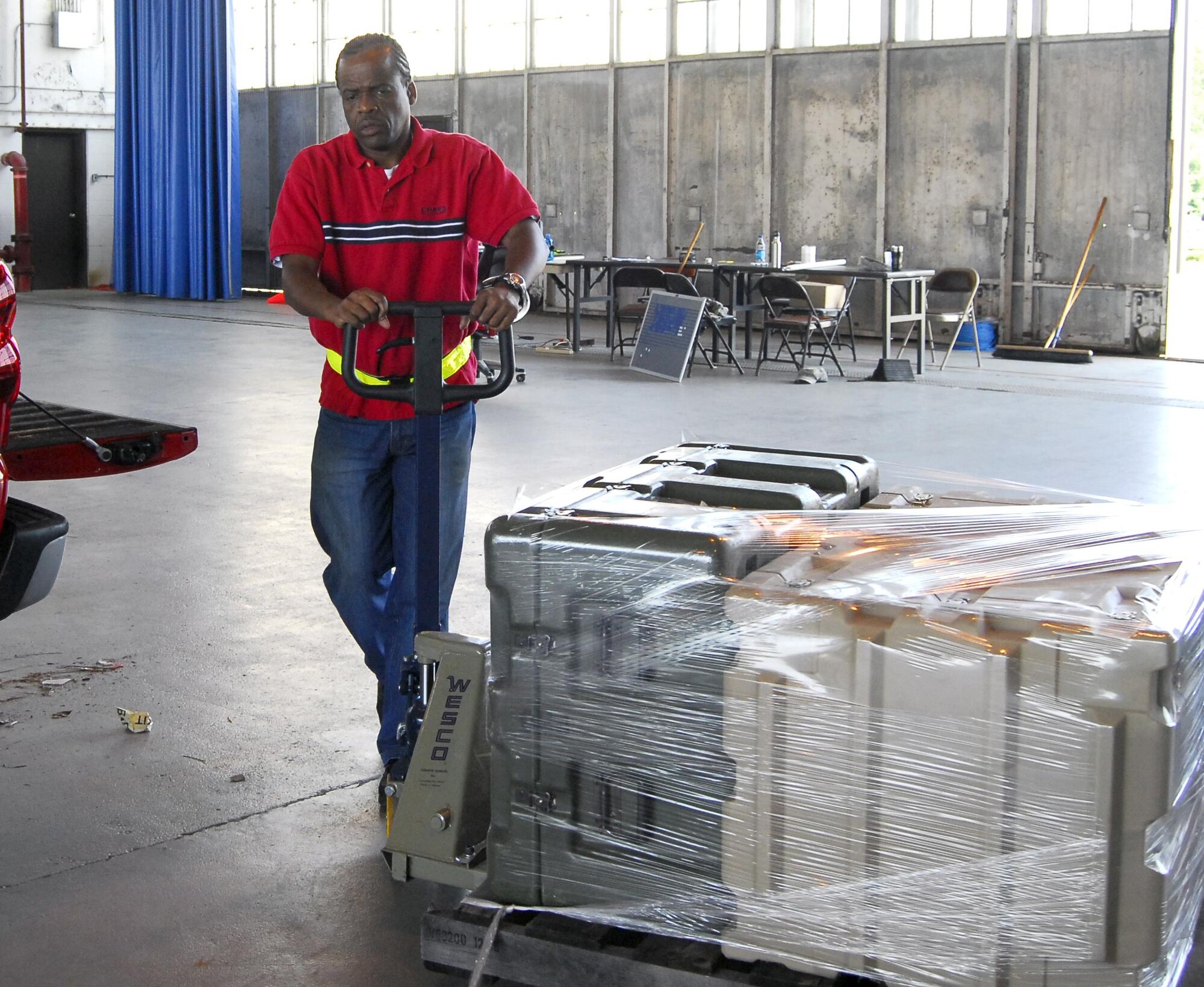 Michael Campbell, 6S event volunteer and member of the 43rd Logistics Readiness Squadron, helps a customer move a pallet of equipment into Hangar 4 on May 20. All of the people helping coordinate the event were volunteers from various organizations around base. (U.S. Air Force photo/Senior Airman Kris Levasseur)