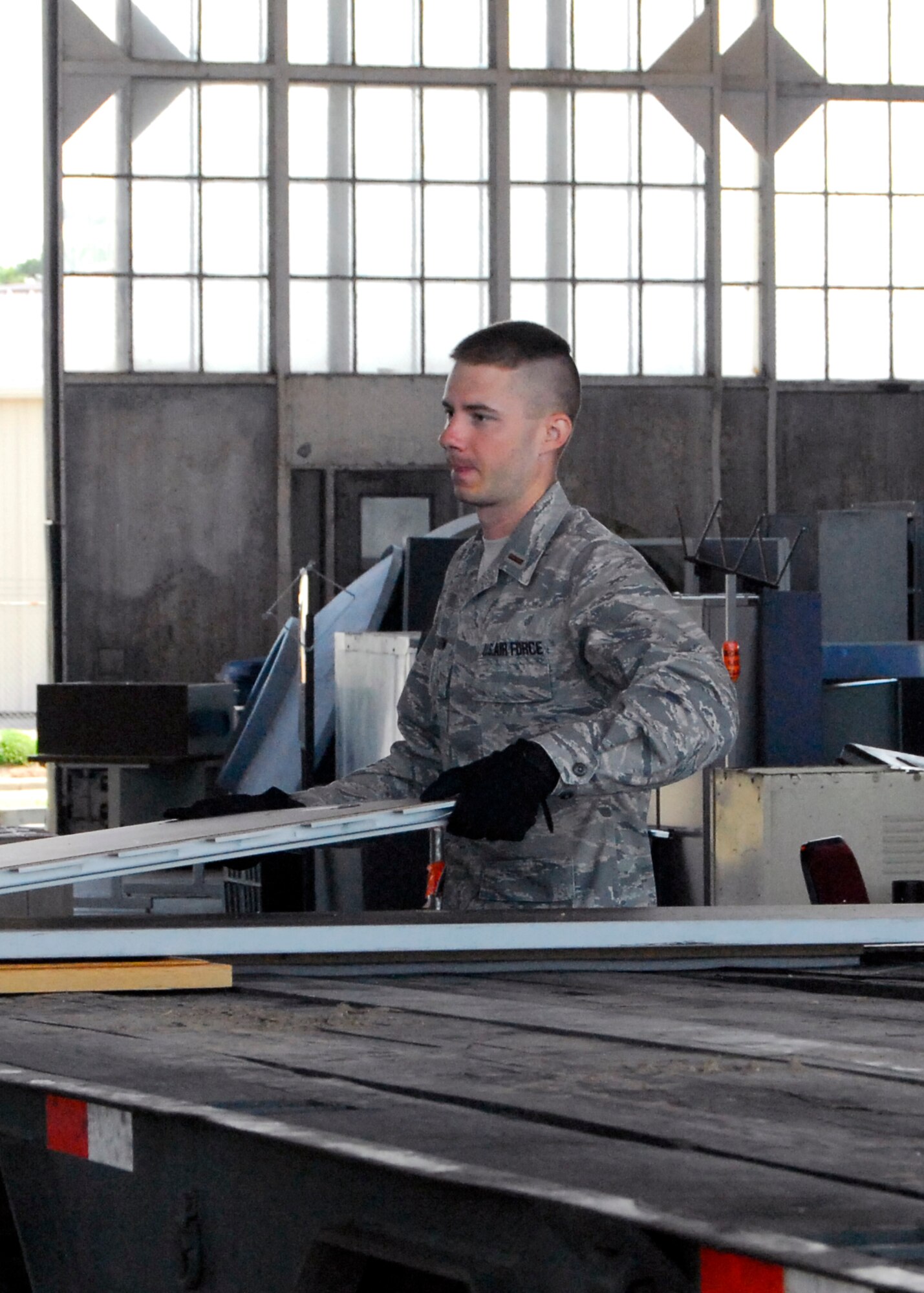 2nd Lt. Luke Jechow, 43rd Force Support Squadron and lead coordinator for the 6S event, moves a panel onto a flat bed truck for removal from Hangar 4 on May 20. The 6S event helped organizations dispose of more than 17,000 pounds of computer equipment and 60,000 pounds of additional equipment. (U.S. Air Force photo/Senior Airman Kris Levasseur)
