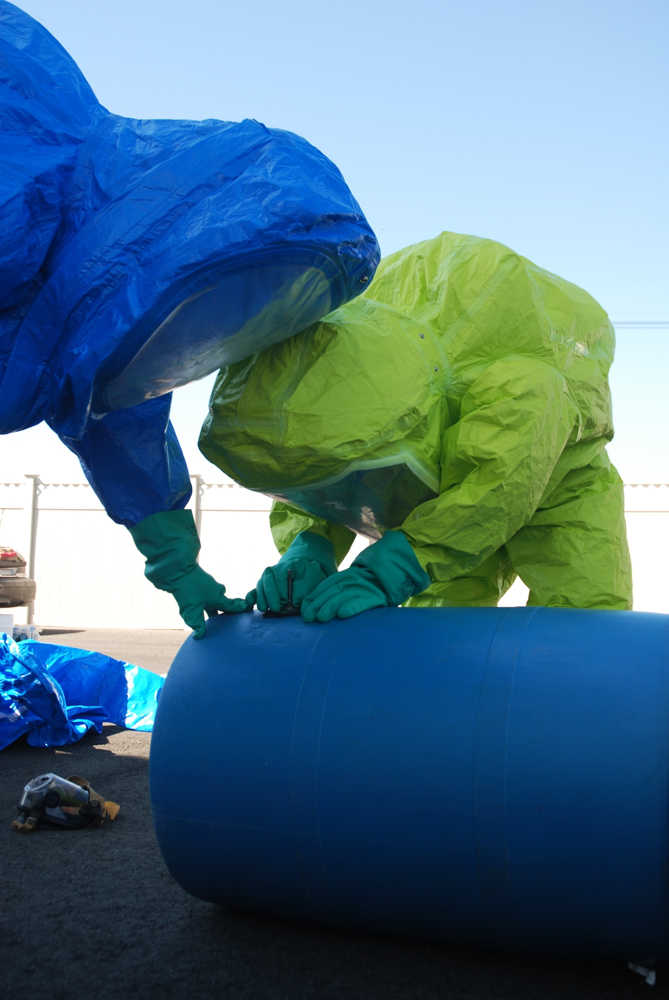 Fire fighters practice patching a simulated leaking drum at the Westover fire training area.  About 20 Fire fighters from around Massachusetts converged on Westover Air Reserve Base to participate in the Massachusetts Fire Fighter Academy's 160-hour Hazardous Materials Technician Course that was hosted here in May.