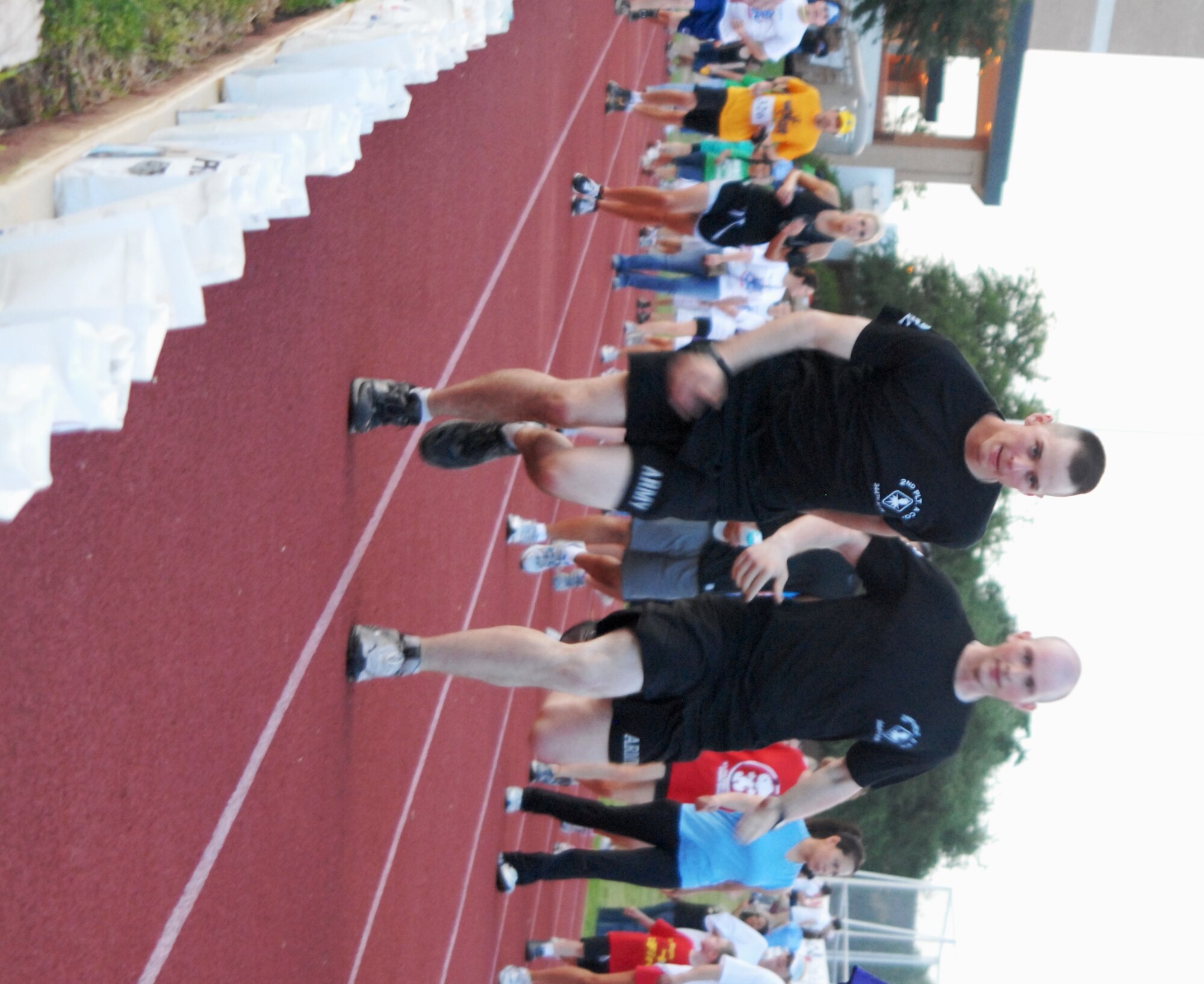 Team Project Imperium members from the Army's 344th Military Intelligence Battalion 2nd Platoon Alpha Company, take turns running laps during the Tom Green County Relay for Life May 21 at the Angelo State University's LeGrand Sports Complex. The team finished the 12-hour event with 271 laps. (U.S. Air Force photo/Connie Hempel)