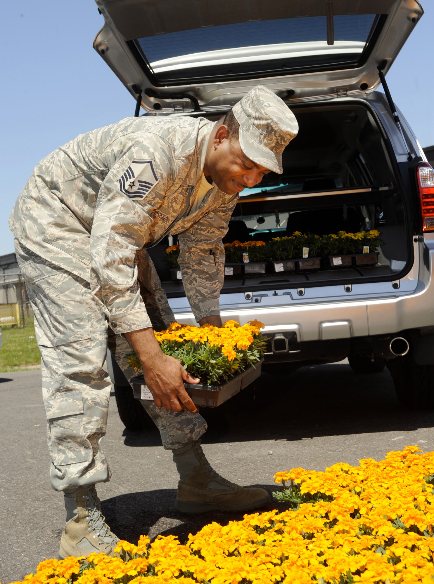 Master Sgt. Timothy Barfield, 87th Force Support Squadron food service superintendent, loads his car with trays of marigolds at the Self Help Center here May 20. Military and civilian personnel spent the day planting flowers, trees and shrubs as part of Base Pride Day.
(U.S. Air Force photo/Carlos Cintron)  
	
