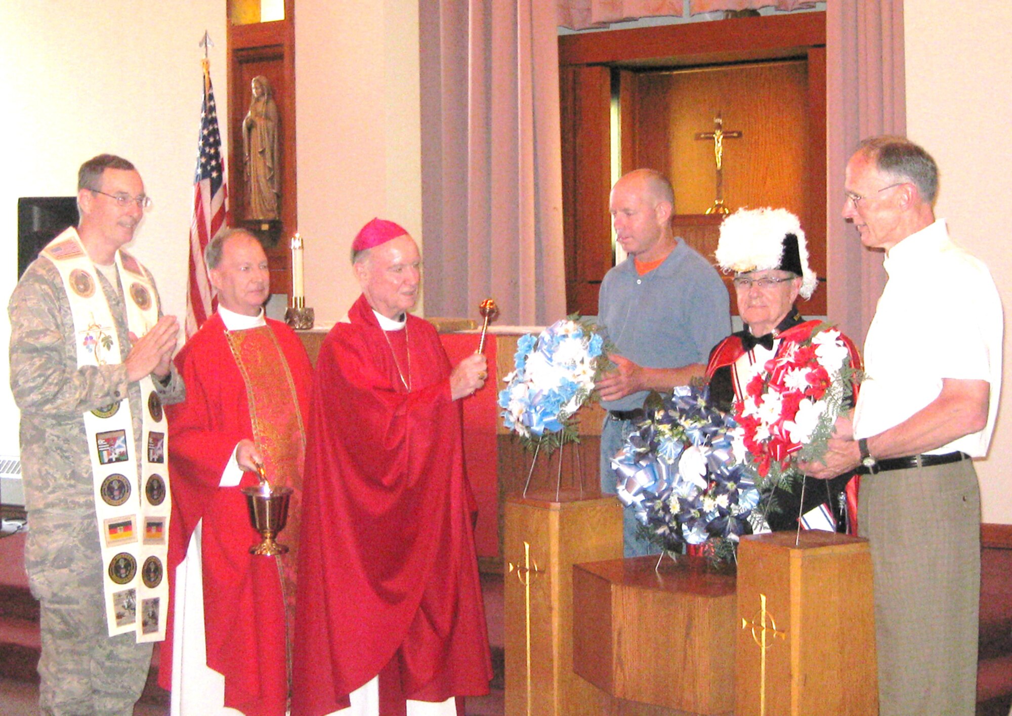 More than 130 members and various delegations from the military community and Knights of Columbus, a chapel organization, placed wreaths to celebrate an early remembrance of Memorial Day at the Carpenter Memorial Chapel, Dover Air Force Base, DE, May 22. (Left to right) Chaplain (Maj.) Timothy Hirten, 436th Airlift Wing chaplain, Chaplain (Lt. Col.) Jack Mink, Delaware Air National Guard Wing Chaplain, Bishop Francis Malooly, Diocese of Wilmington, Master Sgt. Alan Claycomb, 512th Maintenance Group, Bill Wade, Knights of Columbus, a chapel organization, and retired Lt. Col. Steven Welde. (Courtesy photo)