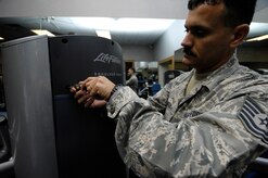 Tech. Sgt. Alexander Oritz tightens the screws on the side panel of the shoulder press at the Fitness and Sports Center on Joint Base Charleston, S.C., May 24, 2010. Sergeant Oritz provides routine maintenance to the machines on a daily basis based on complaints or problems that he spots himself. Sergeant Oritz is a fitness specialist from the 482nd Force Support Squadron at Homestead Air Reserve Base, Fla. (U.S. Air Force Photo/Airman 1st Class Lauren Main)