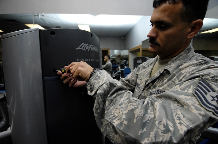 Tech. Sgt. Alexander Oritz tightens the screws on the side panel of the shoulder press at the Fitness and Sports Center on Joint Base Charleston, S.C., May 24, 2010. Sergeant Oritz provides routine maintenance to the machines on a daily basis based on complaints or problems that he spots himself. Sergeant Oritz is a fitness specialist from the 482nd Force Support Squadron at Homestead Air Reserve Base, Fla. (U.S. Air Force Photo/Airman 1st Class Lauren Main)