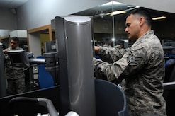 Tech. Sgt. Alexander Oritz tightens the screws on the side panel of the shoulder press at the Fitness and Sports Center on Joint Base Charleston, S.C., May 24, 2010. The panel was previously missing screws and hanging loosely from the machine, causing it to be a potential hazard for someone. Sergeant Oritz provides routine maintenance to the machines on a daily basis based on complaints or problems that he spots himself. Sergeant Oritz is a fitness specialist from the 482nd Force Support Squadron at Homestead Air Reserve Base, Fla. (U.S. Air Force Photo/Airman 1st Class Lauren Main)