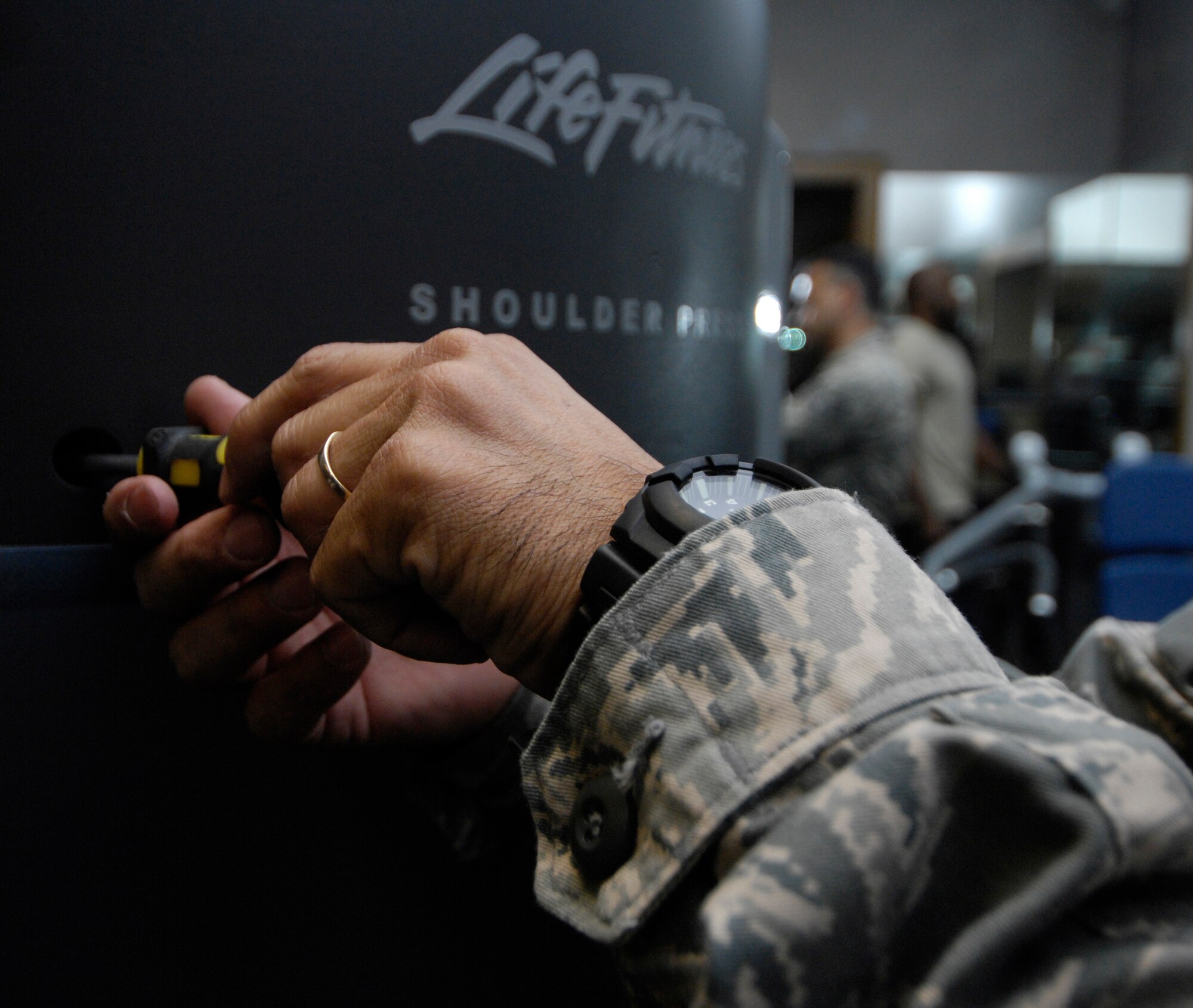 Tech. Sgt. Alexander Oritz tightens the screws on the side panel of the shoulder press at the Ftiness and Sports Center on Joint Base Charleston, S.C., May 24, 2010. Sergeant Oritz provides routine maintenance to the machines on a daily basis based on complaints or problems that he spots himself. Sergeant Oritz is a fitness specialist from the 482nd Force Support Squadron at Homestead Air Reserve Base, Fla. (U.S. Air Force Photo/Airman 1st Class Lauren Main)