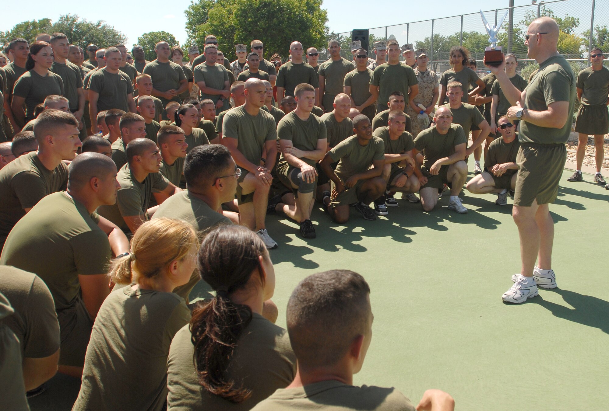 Captain Douglas March, Marine Corp Detachment commander, congratulates the Marines of Goodfellow for winning the sports day competition, 21 May. Sports day provided a variety of activities for all participants including volleyball, tennis, swimming and more. (U.S. Air Force photo/Master Sgt. Randy Mallard)