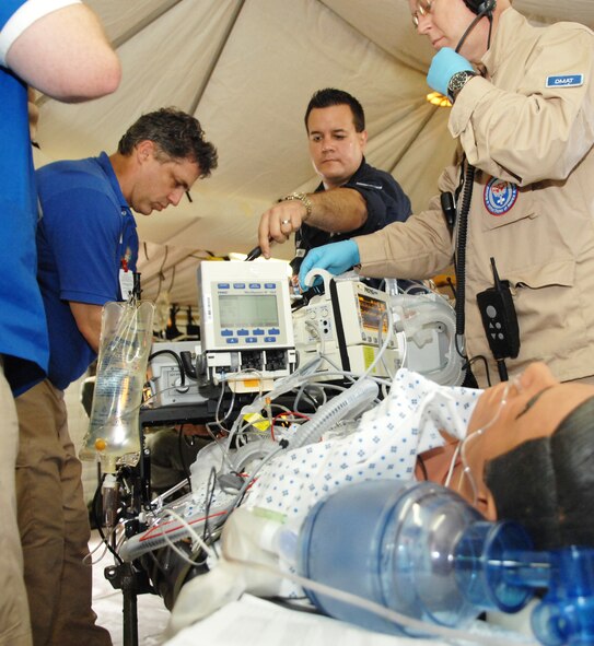 NEW ORLEANS -- Disaster Medical Operations Detachment members from Hawaii, Tennessee and New York work together to sustain a critical care patient during an evacuation exercise on the New Orleans Lakefront Airport flighline May 19. The exercise was controlled by the Louisiana Department of Health and Hospitals with the help of multiple military counterparts including Air Mobility Command and U.S. Transportation Command members from Scott AFB. (U.S. Air Force photo by Senior Airman Samantha S. Crane)