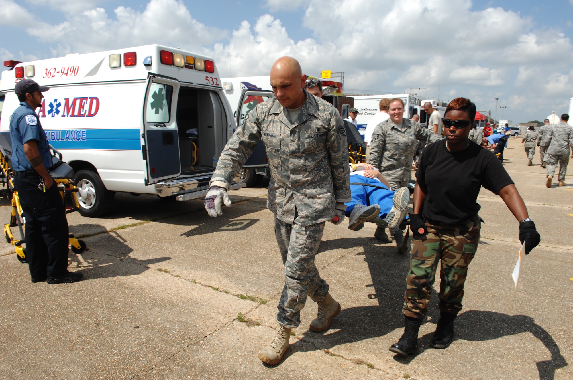 NEW ORLEANS -- Members of the Disaster Aeromedical Staging Facility carry a patient into the facility during an evacuation exercise on the New Orleans Lakefront Airport flighline May 20. The exercise was controlled by the Louisiana Department of Health and Hospitals with the help of multiple military counterparts including Air Mobility Command and U.S. Transportation Command members from Scott AFB. (U.S. Air Force photo by Senior Airman Samantha S. Crane)