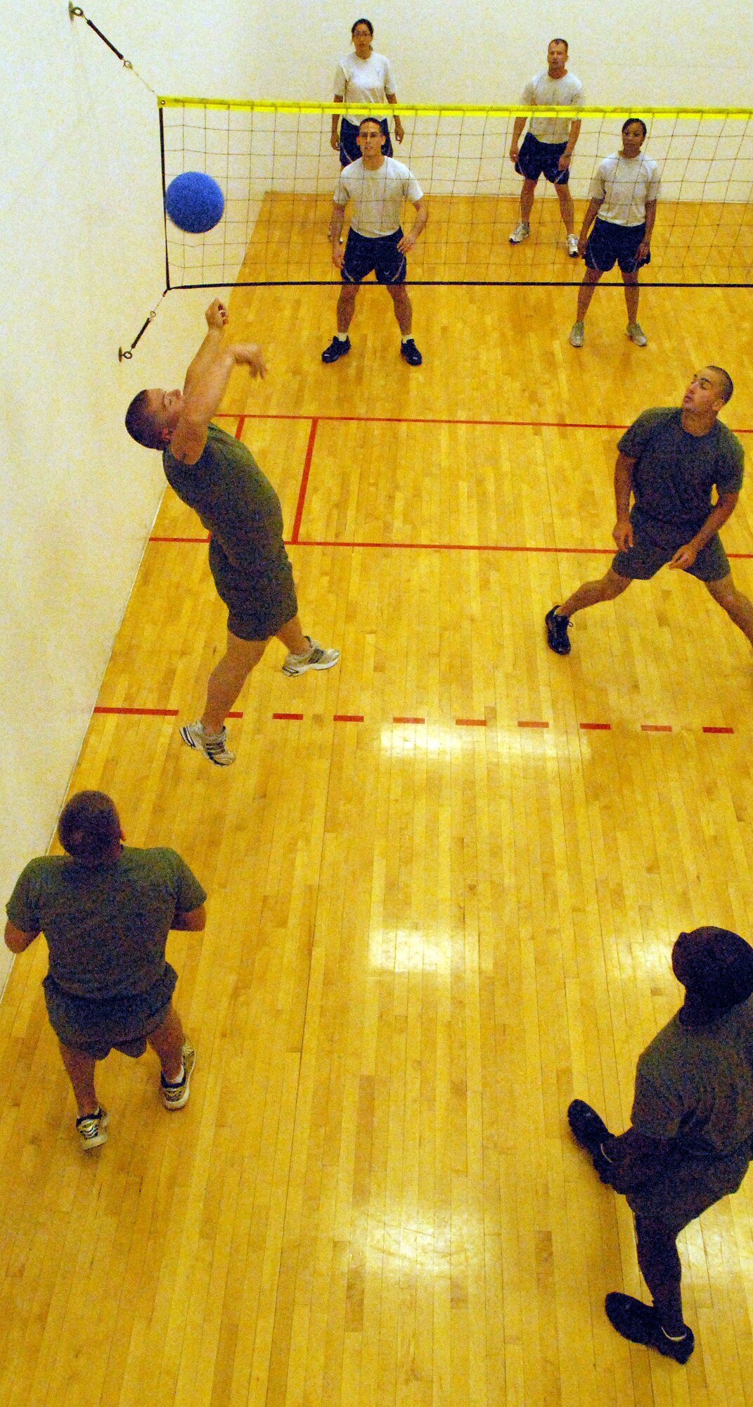 A member of the Goodfellow Marine Corp Detachment returns the ball during a sports day Wally Ball tournament, May 21.  Sports day provided a variety of activities for all participants including volleyball, tennis, swimming and more. (U.S. Air Force photo/Master Sgt. Randy Mallard)