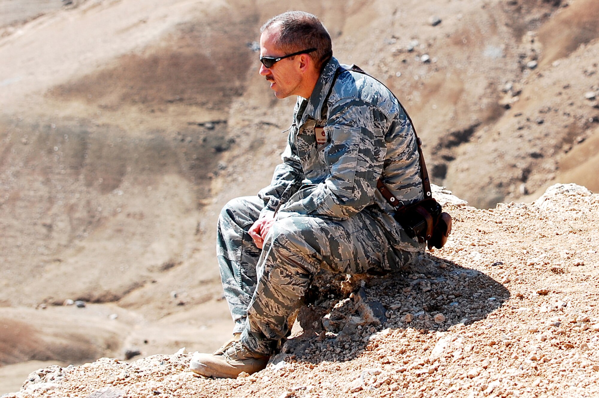 KABUL INTERNATIONAL AIRPORT, Afghanistan -- Master Sgt. Robert Van De Hey waits to observe helicopters firing their rockets during live-fire training as part of his range safety officer duties while deployed.