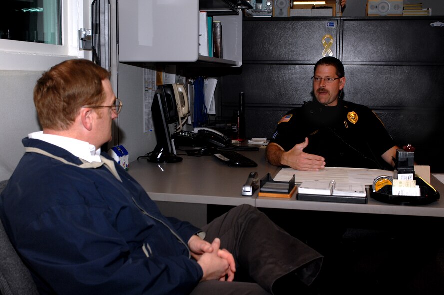 MINOT, N.D. -- Sgt. Paul C. Burns, Minot Police Department shift commander, briefs Col. Douglas A. Cox, 5th Bomb Wing commander at the police department here May 21. Colonel Cox was downtown to participate in the Minot AFB & Minot PD Supervisor 'Ride-Along' Program. The new program is designed to enhance the partnership between base officials and local law enforcement and help increase the understanding of the areas of concern related to DUI incidents among the base population.  (U.S. Air Force photo by Airman 1st Class Aaron-Forrest Wainwright)